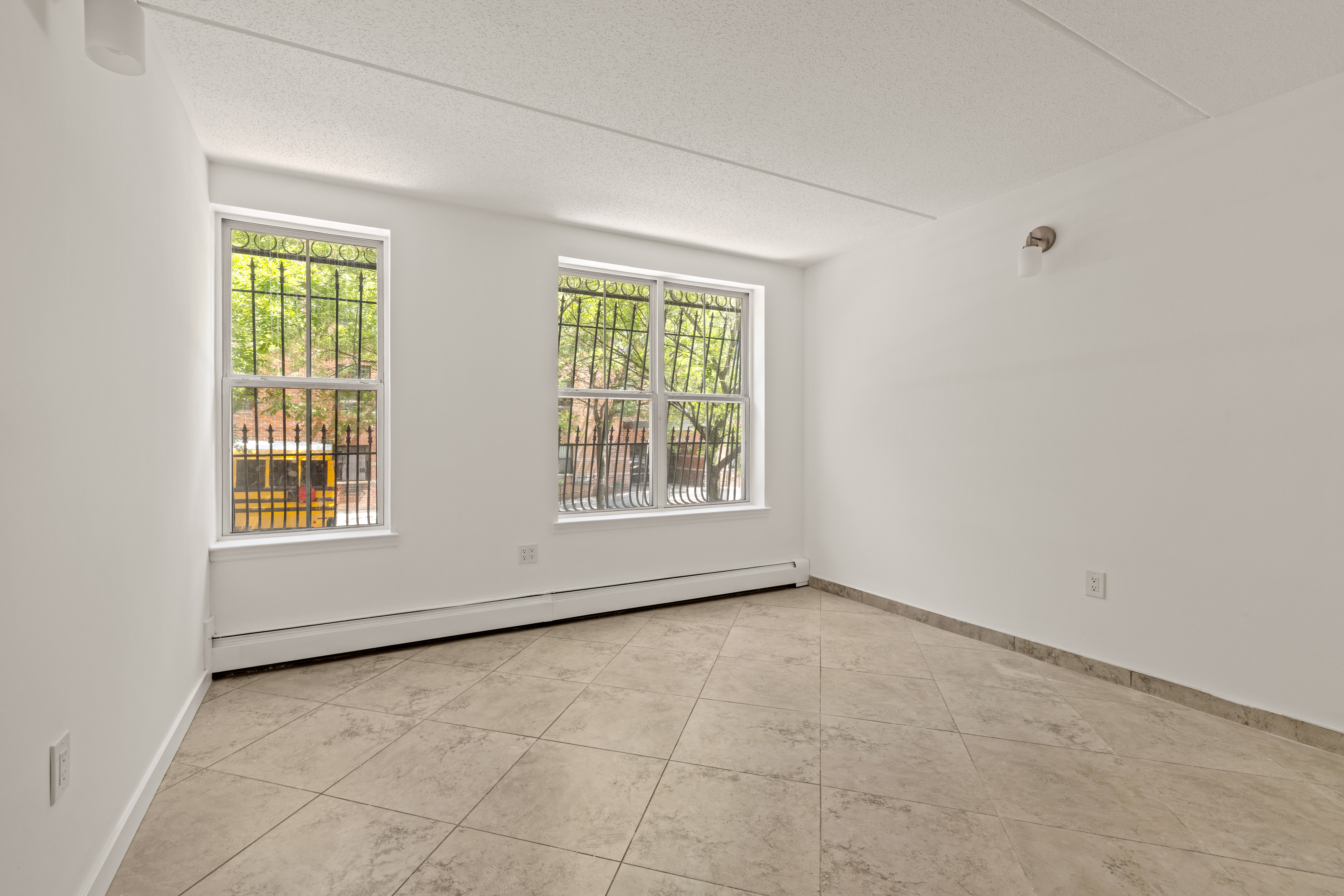 175 Eldert Street, Unit 2 Brooklyn, NY 11207 - Photo 4 of 15 a view of an empty room with a window