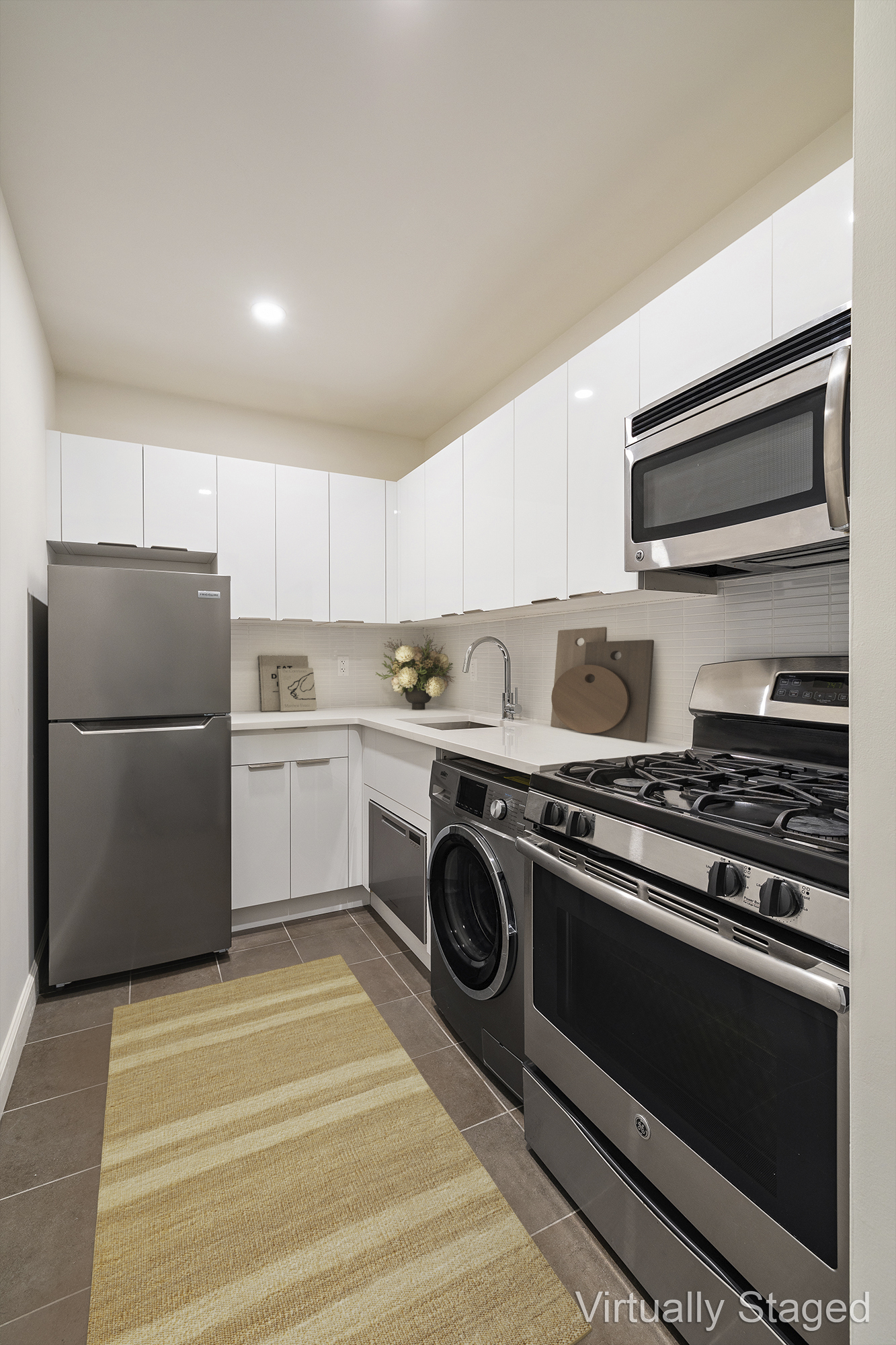 194 East 2nd Street, Unit 4A Manhattan, NY 10009 - Photo 5 of 13 a kitchen with a stove and a refrigerator