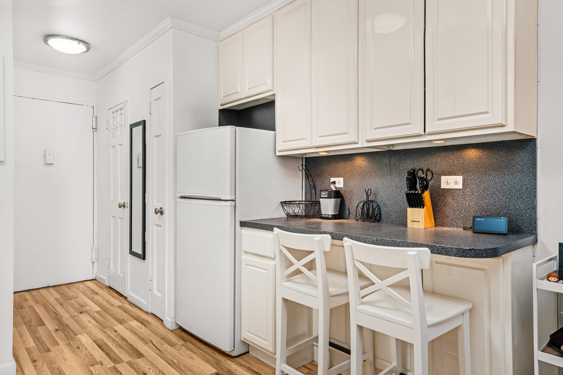 122 Ashland Place, Unit 14F Brooklyn, NY 11201 - Photo 4 of 16 a kitchen with stainless steel appliances granite countertop a refrigerator and cabinets
