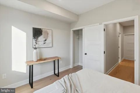 a bedroom with a bed and a lamp on table
