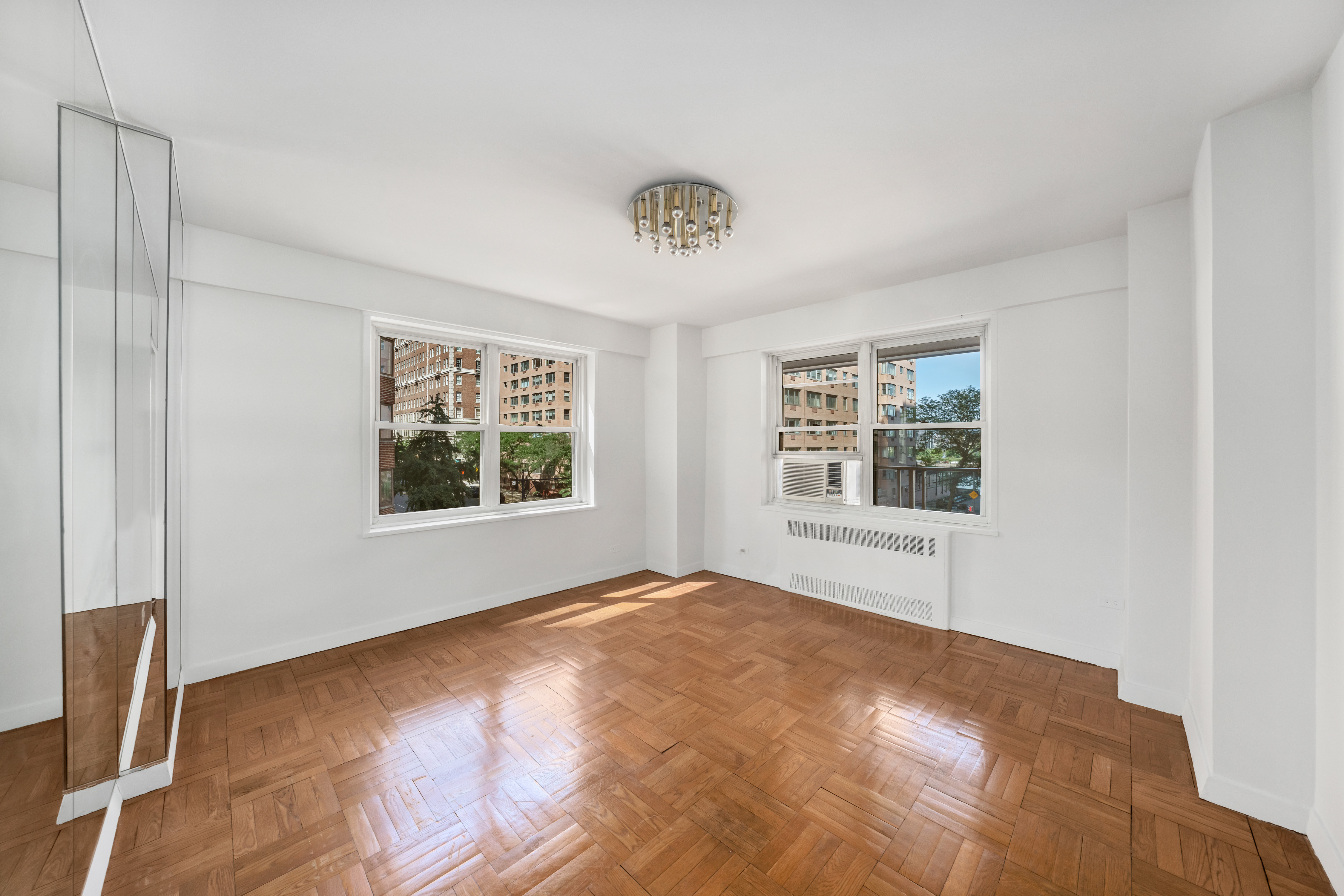 50 Sutton Place South, Unit 5E Manhattan, NY 10022 - Photo 5 of 13 a view of an empty room with a window