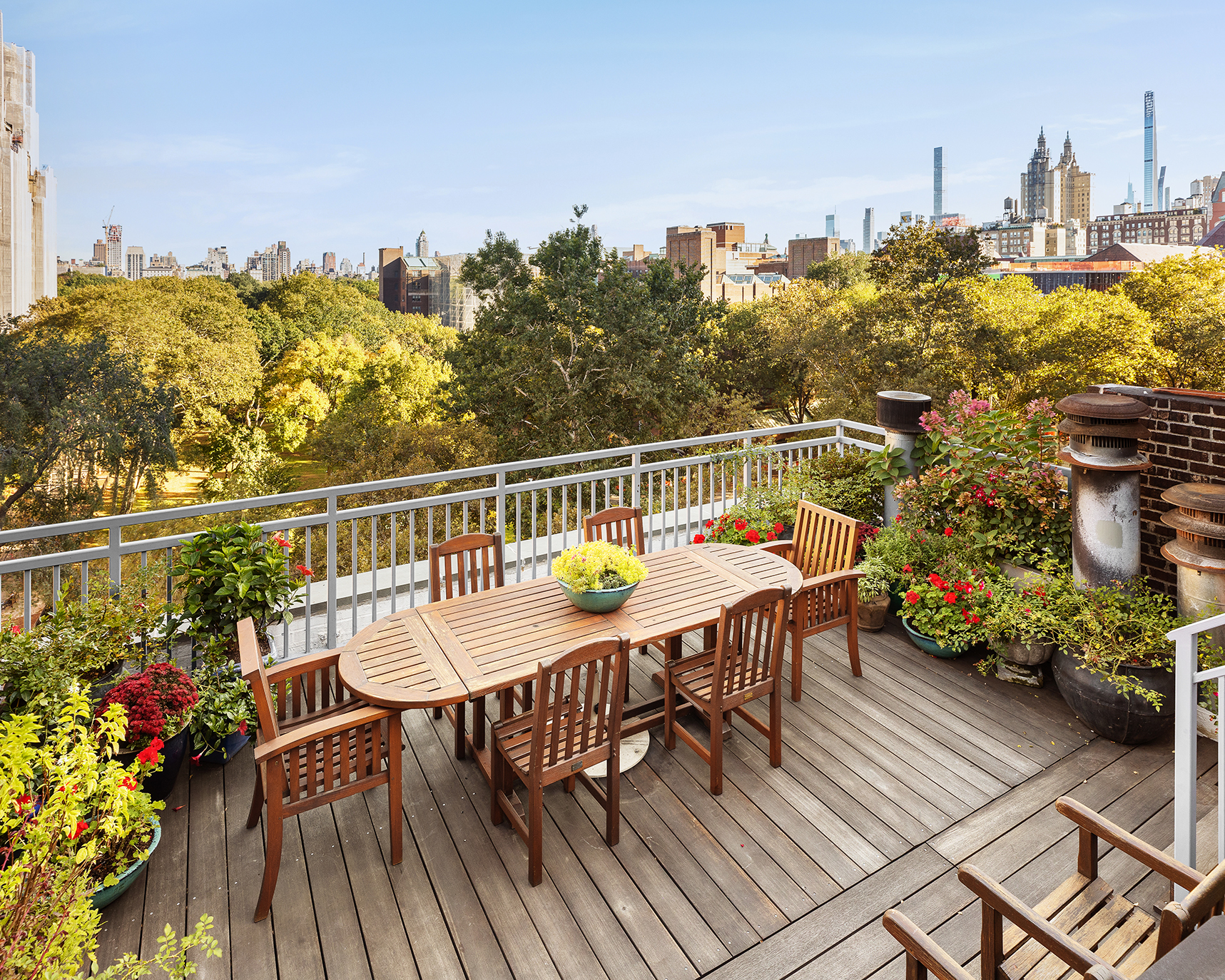 428 Columbus Avenue, Unit PH Manhattan, NY 10024 - Photo 2 of 21 a balcony with wooden floor table and chairs