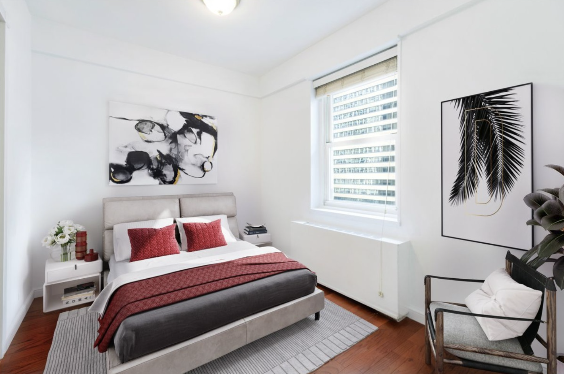 159 West 53rd Street, Unit 36C Manhattan, NY 10019 - Photo 4 of 9 a bedroom with a bed and dresser with wooden floor