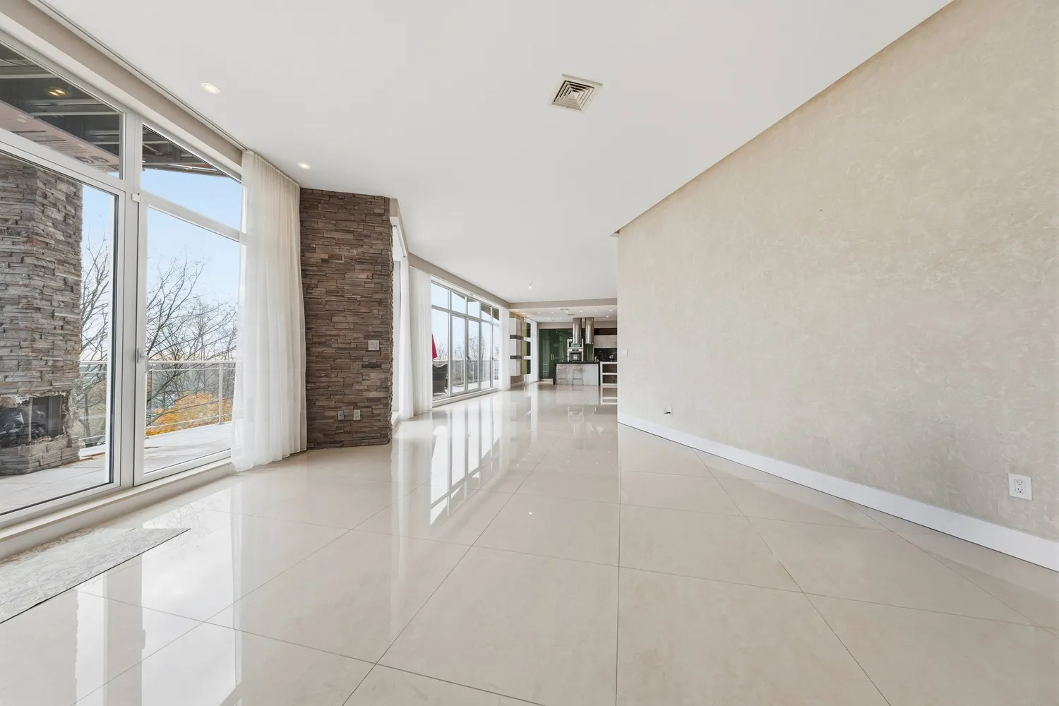 a view of an empty room with glass door