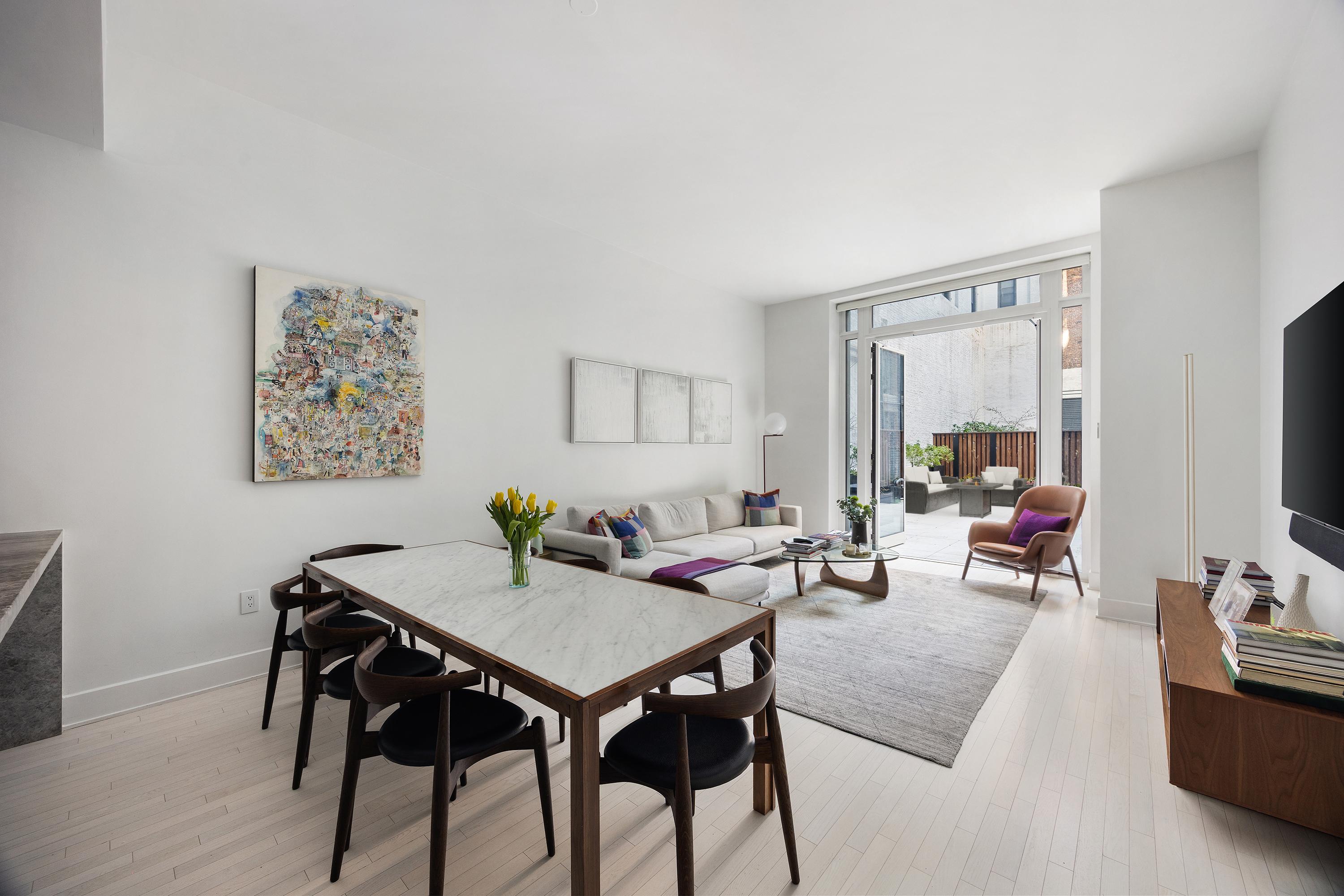 91 Leonard Street, Unit 2C Manhattan, NY 10013 - Photo 2 of 23 a living room with furniture and a flat screen tv