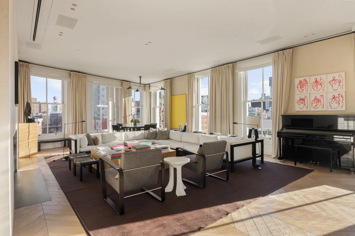 a living room with lots of furniture and a large window