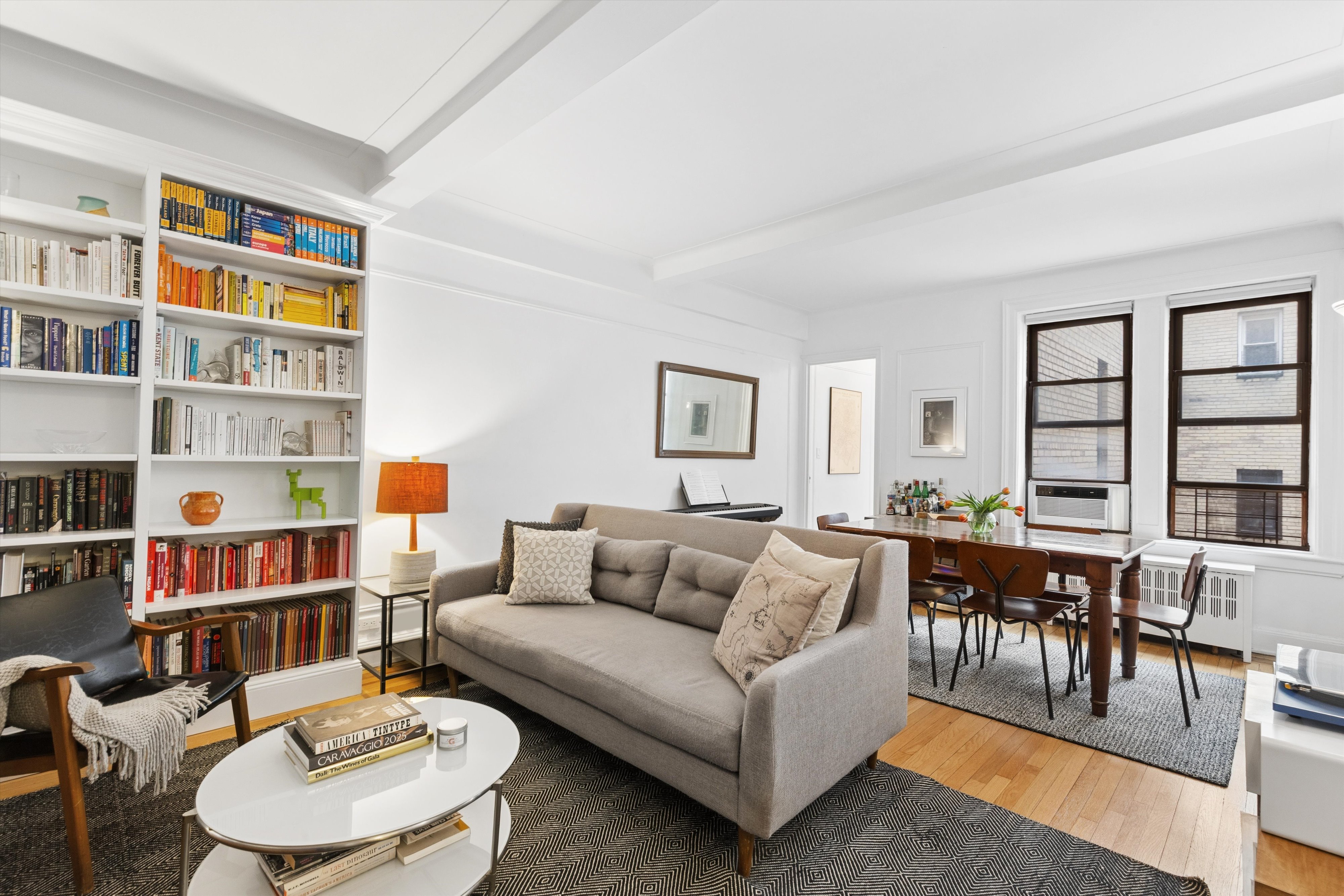 a living room with furniture and a book shelf