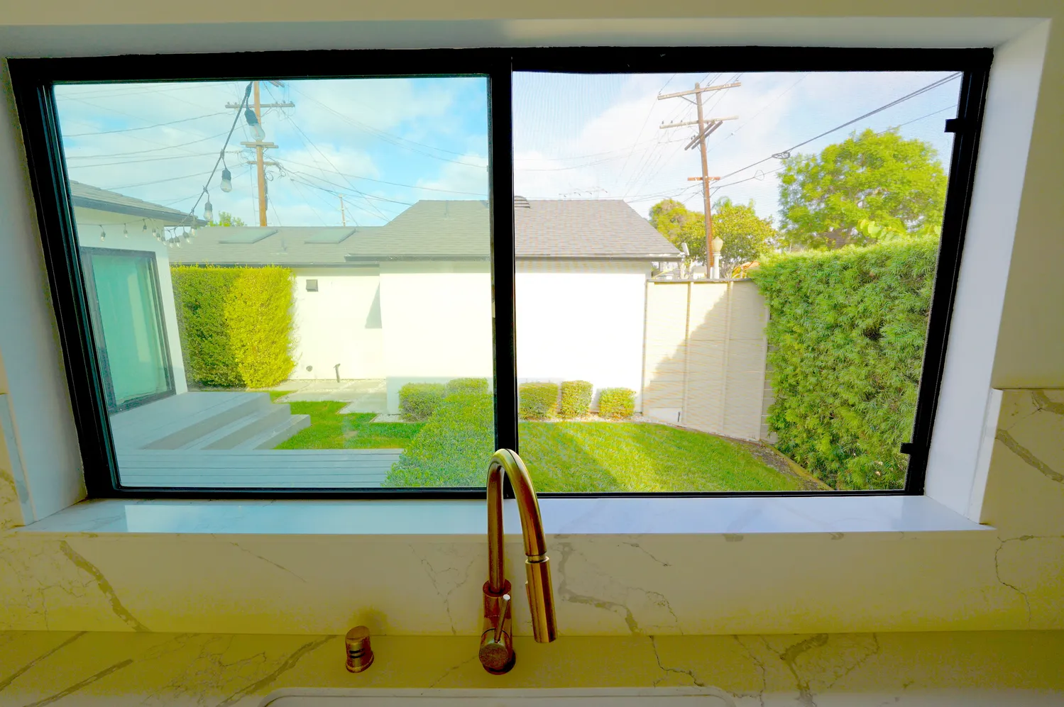 a view of a dining room with furniture a kitchen and chandelier