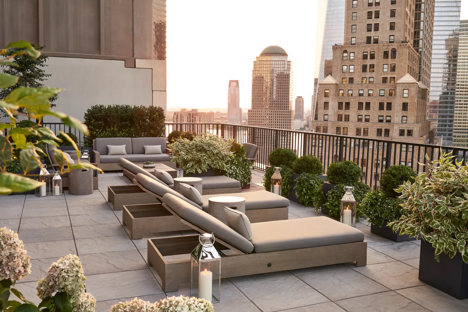 a roof deck with couch and potted plants