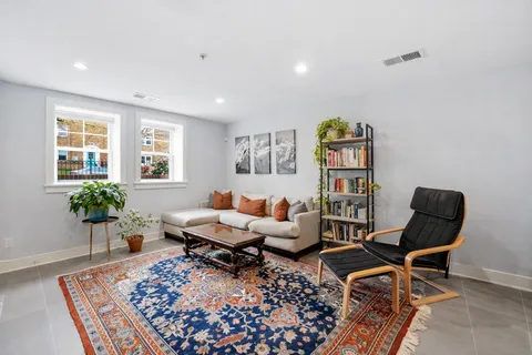 a living room with furniture and a potted plant