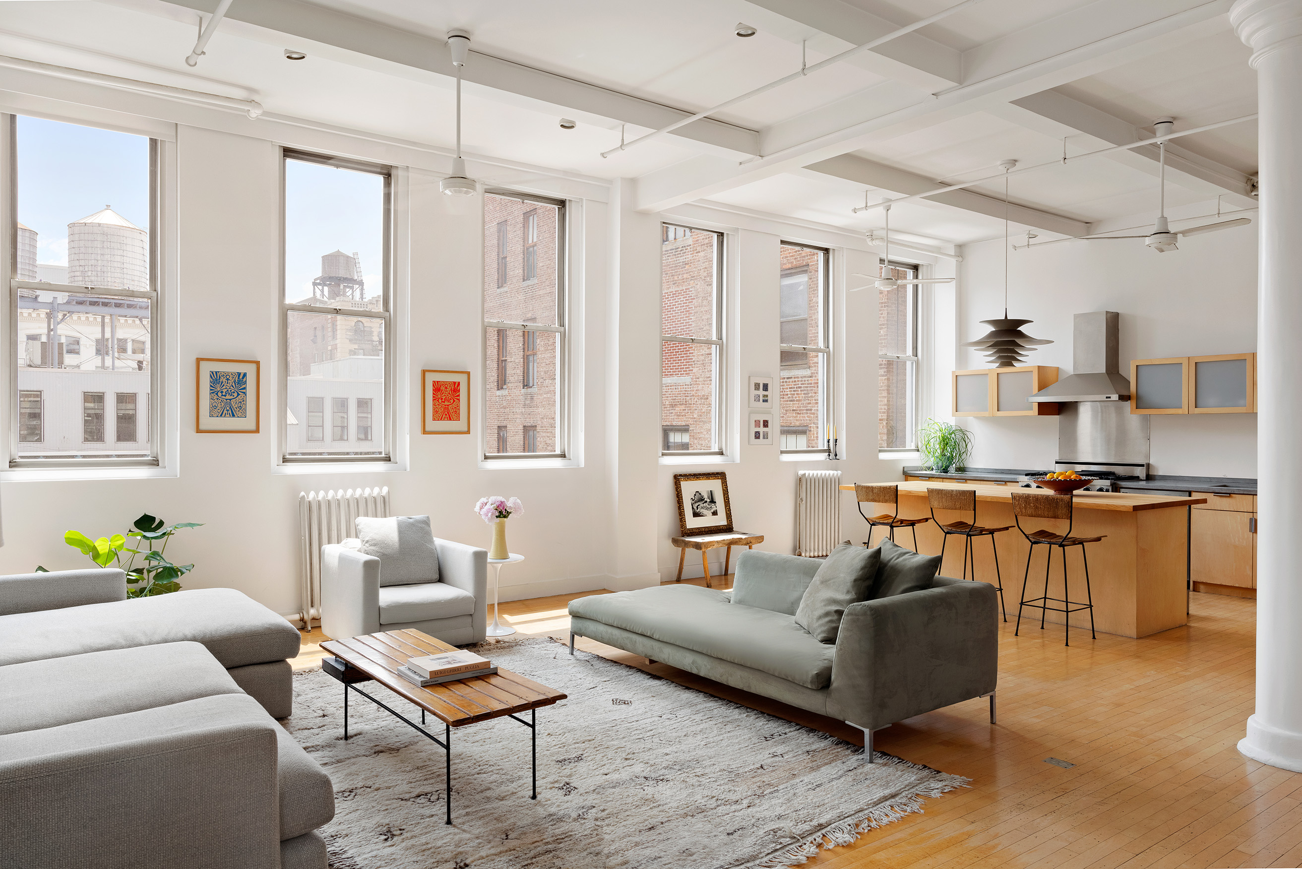 32 West 20th Street, Unit 9B Manhattan, NY 10011 - Photo 1 of 16 a living room with furniture and a kitchen area