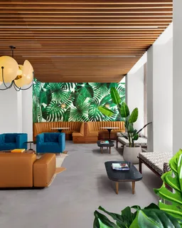 a living room with patio furniture and a potted plant