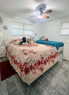 a bedroom with bed and window