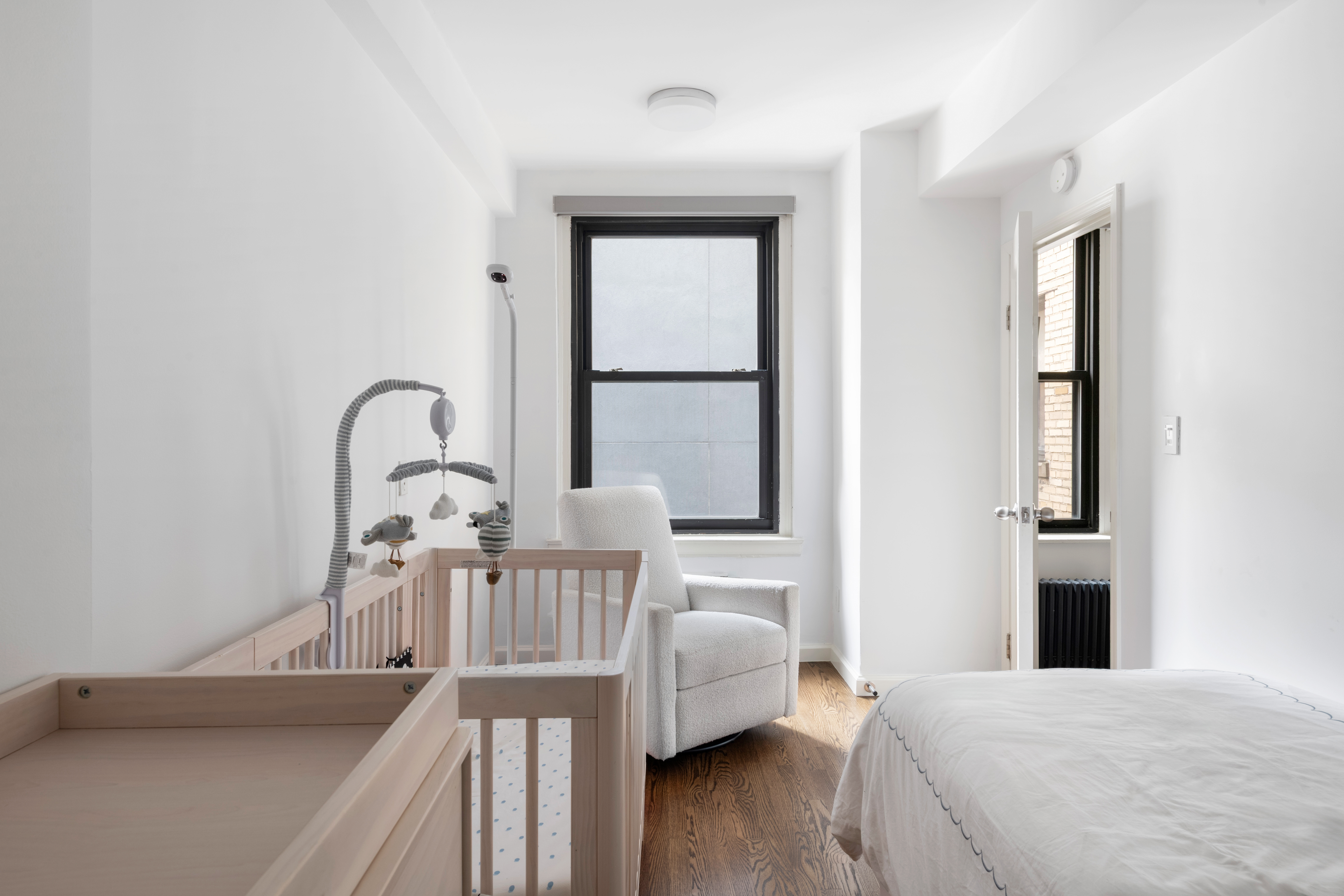 308 East 79th Street, Unit 13EF Manhattan, NY 10075 - Photo 10 of 16 a bedroom with a bed and a large window