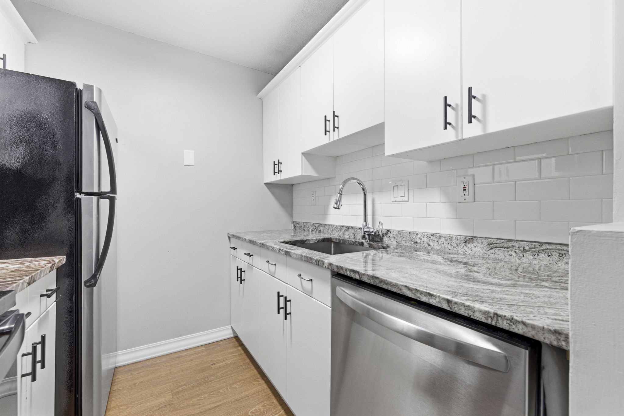 61 Wright Street, Unit 102 Stoneham, MA 02180 - Photo 9 of 26 a kitchen with stainless steel appliances granite countertop a sink stove and refrigerator