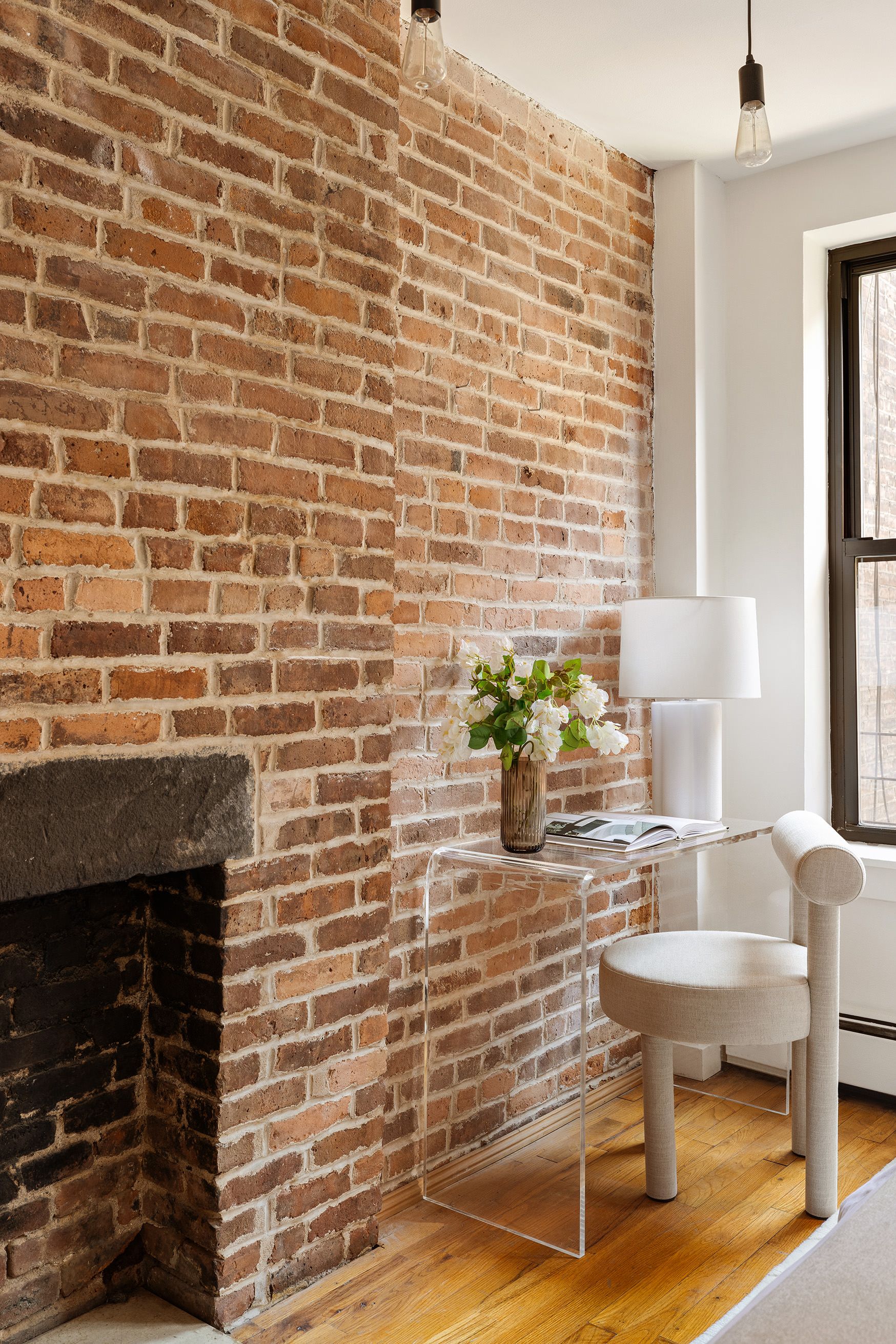 410 West 25th Street, Unit 2B Manhattan, NY 10001 - Photo 6 of 9 a brick wall with a fireplace