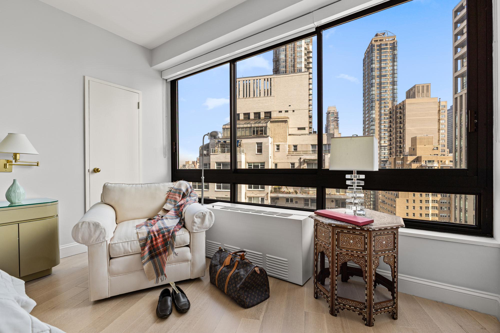 167 East 61st Street, Unit 20E Manhattan, NY 10065 - Photo 16 of 24 a living room with furniture and a window