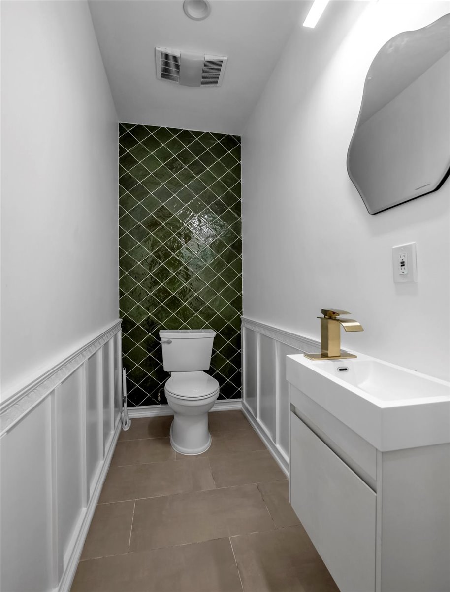 448 Halsey Street, Unit 1 Brooklyn, NY 11233 - Photo 11 of 22 a bathroom with a toilet sink and mirror
