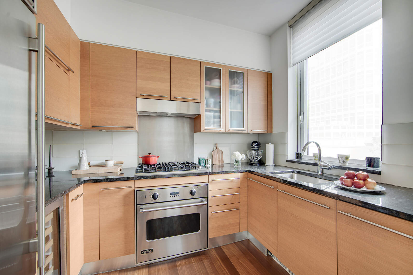 10 West End Avenue, Unit 4J Manhattan, NY 10023 - Photo 4 of 15 a kitchen with stainless steel appliances granite countertop a sink stove and cabinets