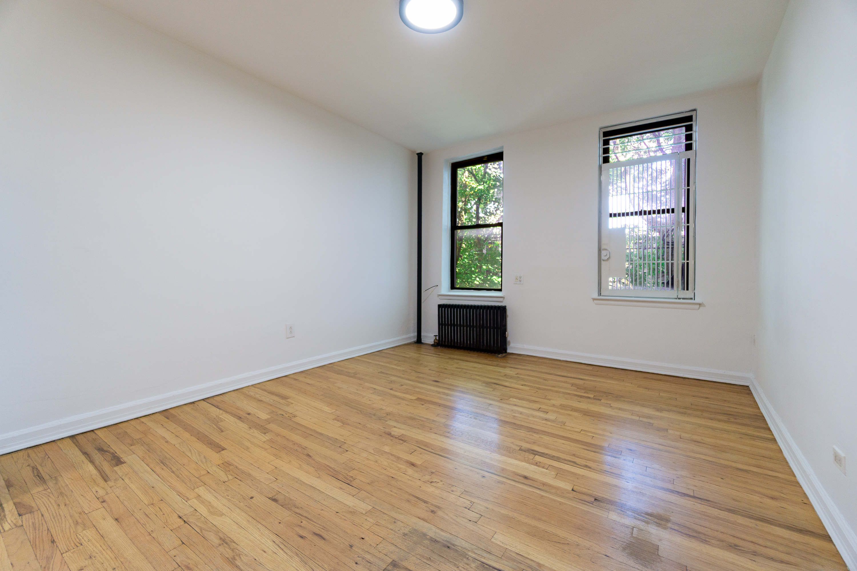 319 East 5th Street, Unit 13 Manhattan, NY 10003 - Photo 3 of 13 an empty room with windows
