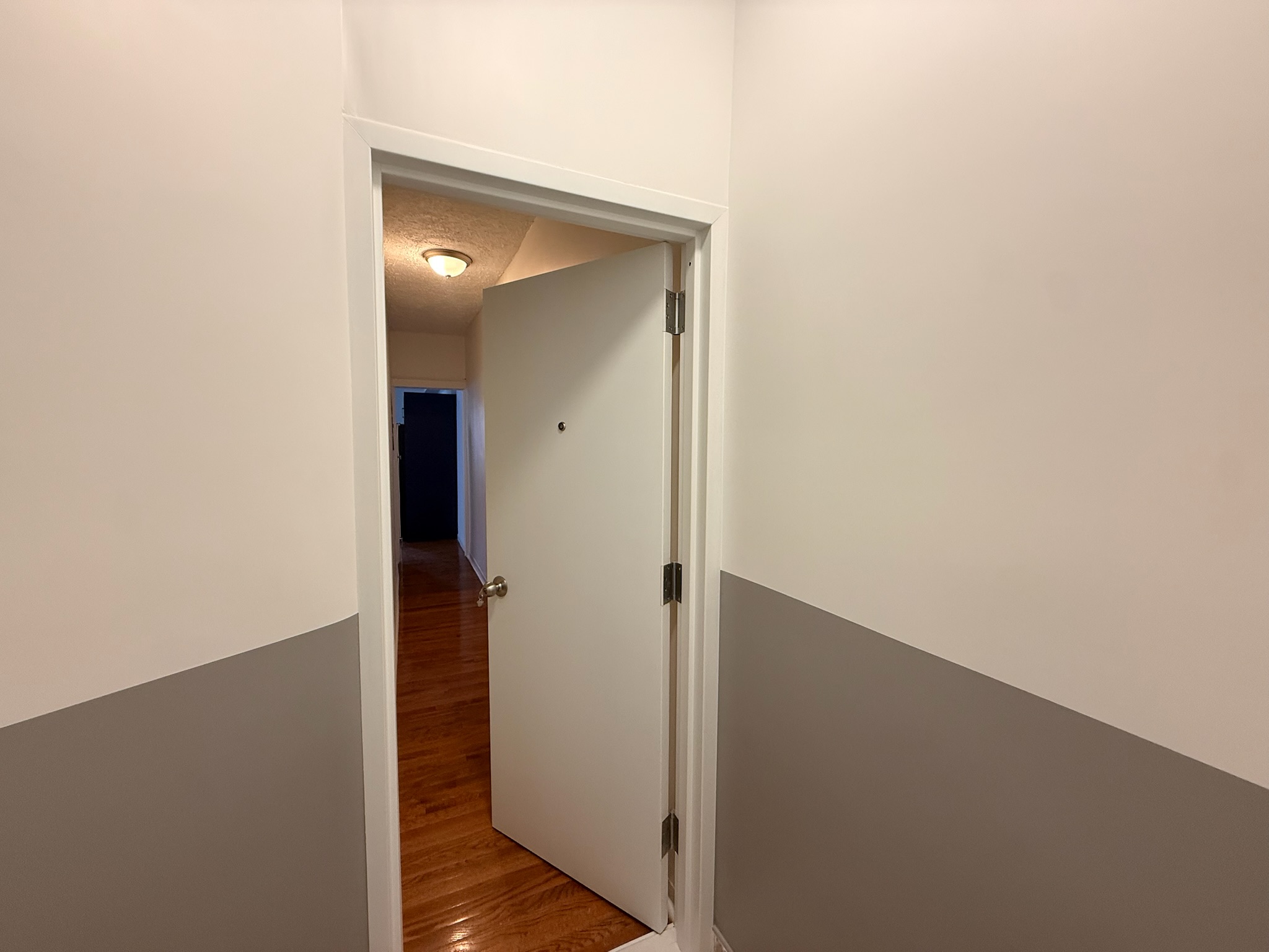1675 85th Street, Unit 1R Brooklyn, NY 11214 - Photo 2 of 8 a view of a hallway with wooden floor