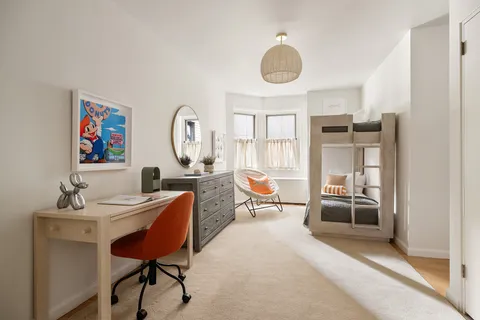 a bathroom with a sink mirror and a shower