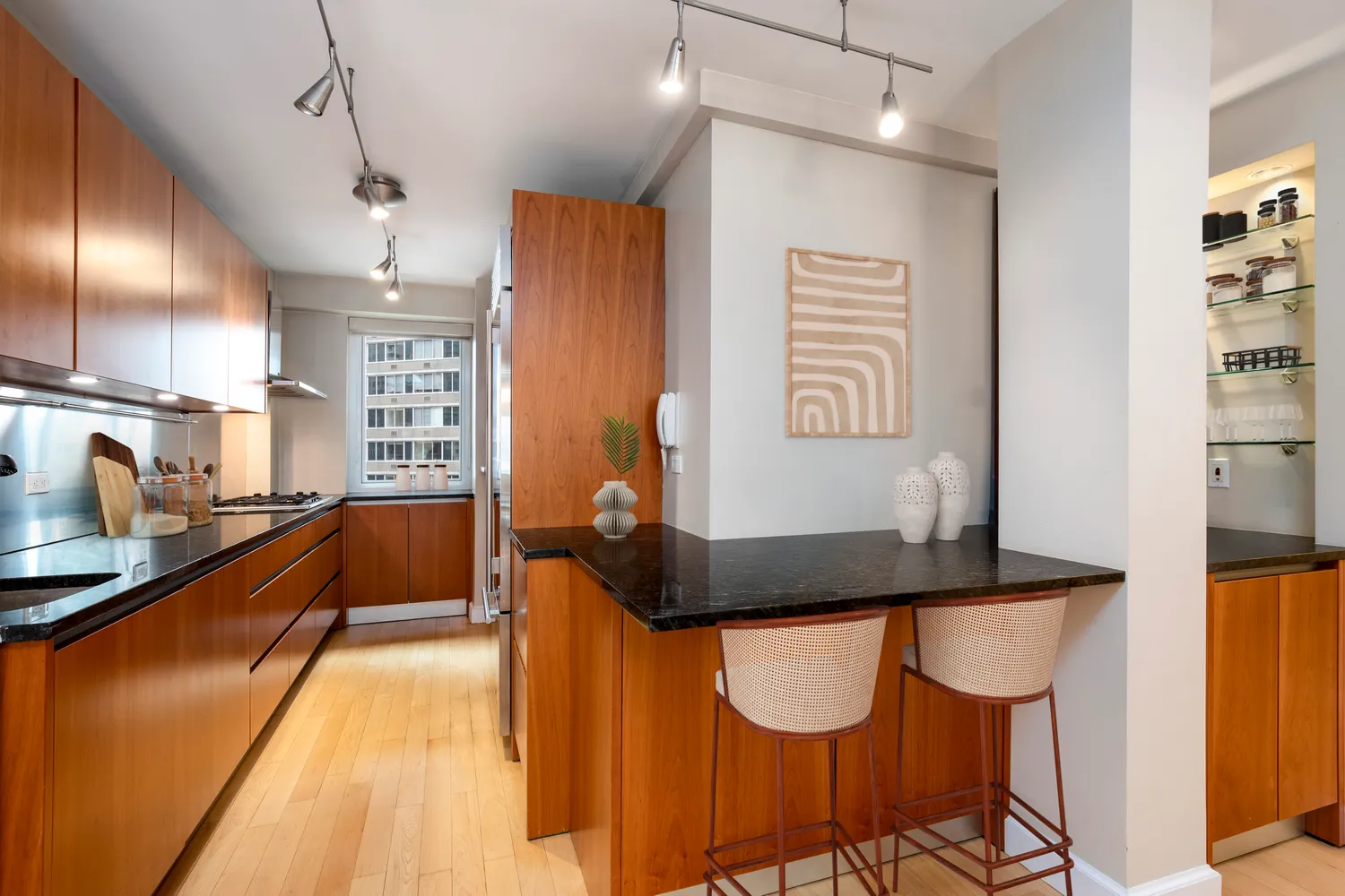 a kitchen with granite countertop sink and cabinets