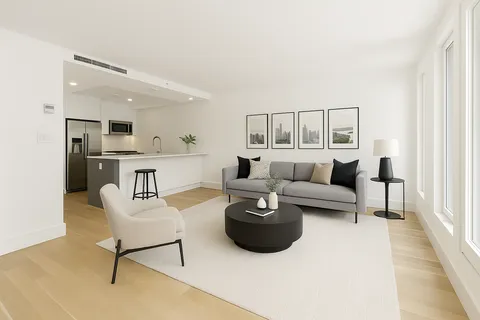 a living room with furniture and a kitchen view