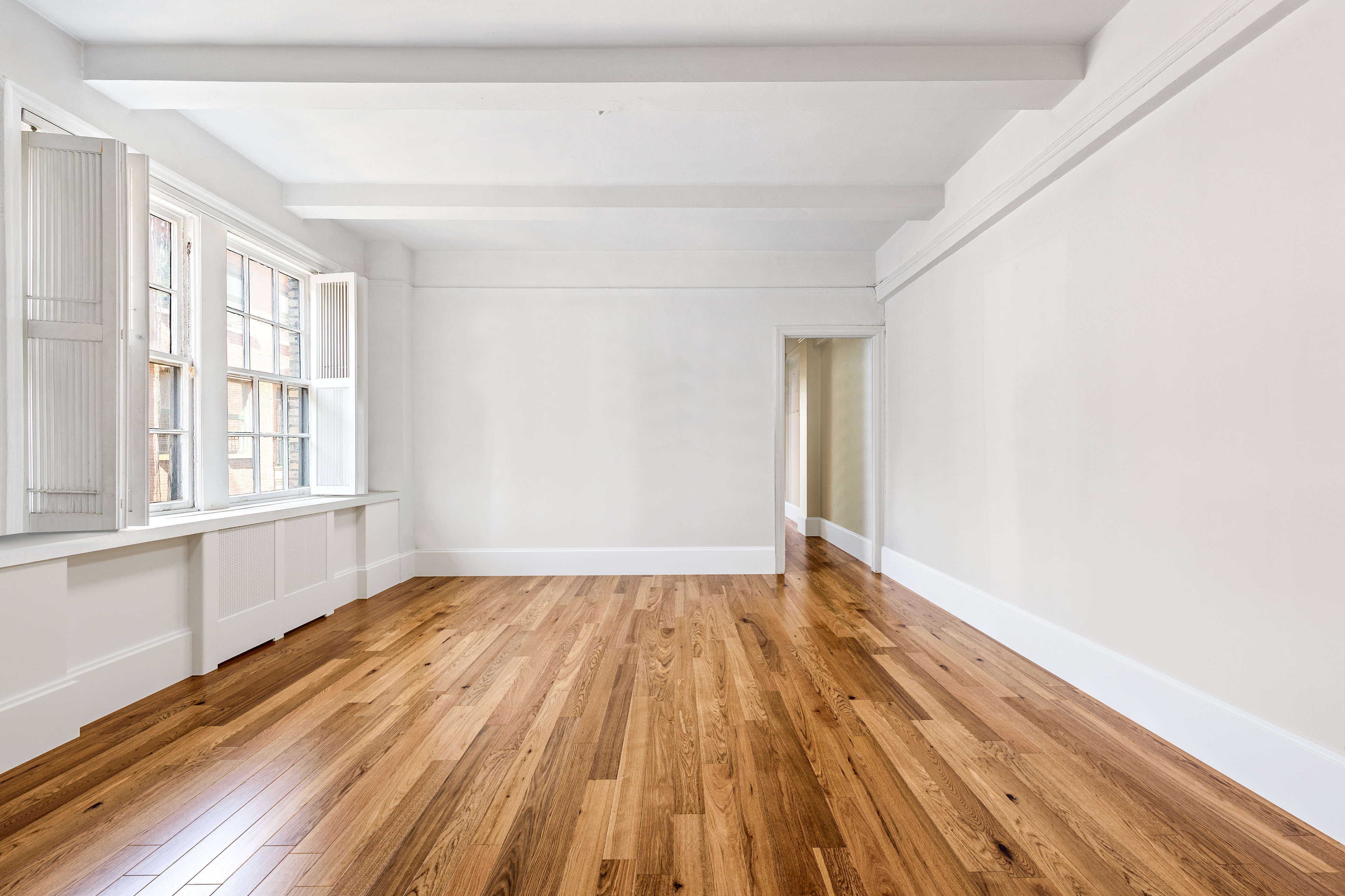 264 Lexington Avenue, Unit 4B Manhattan, NY 10016 - Photo 7 of 10 a view of an empty room with wooden floor and a window