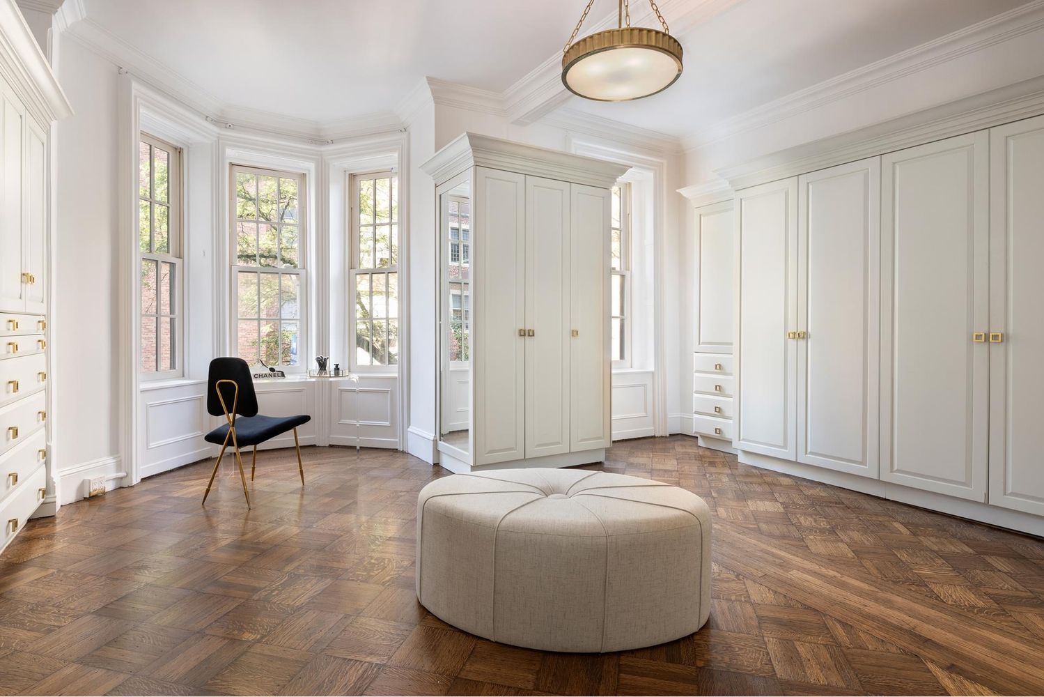 136 East 65th Street Manhattan, NY 10065 - Photo 9 of 20 a living room with furniture and a large window