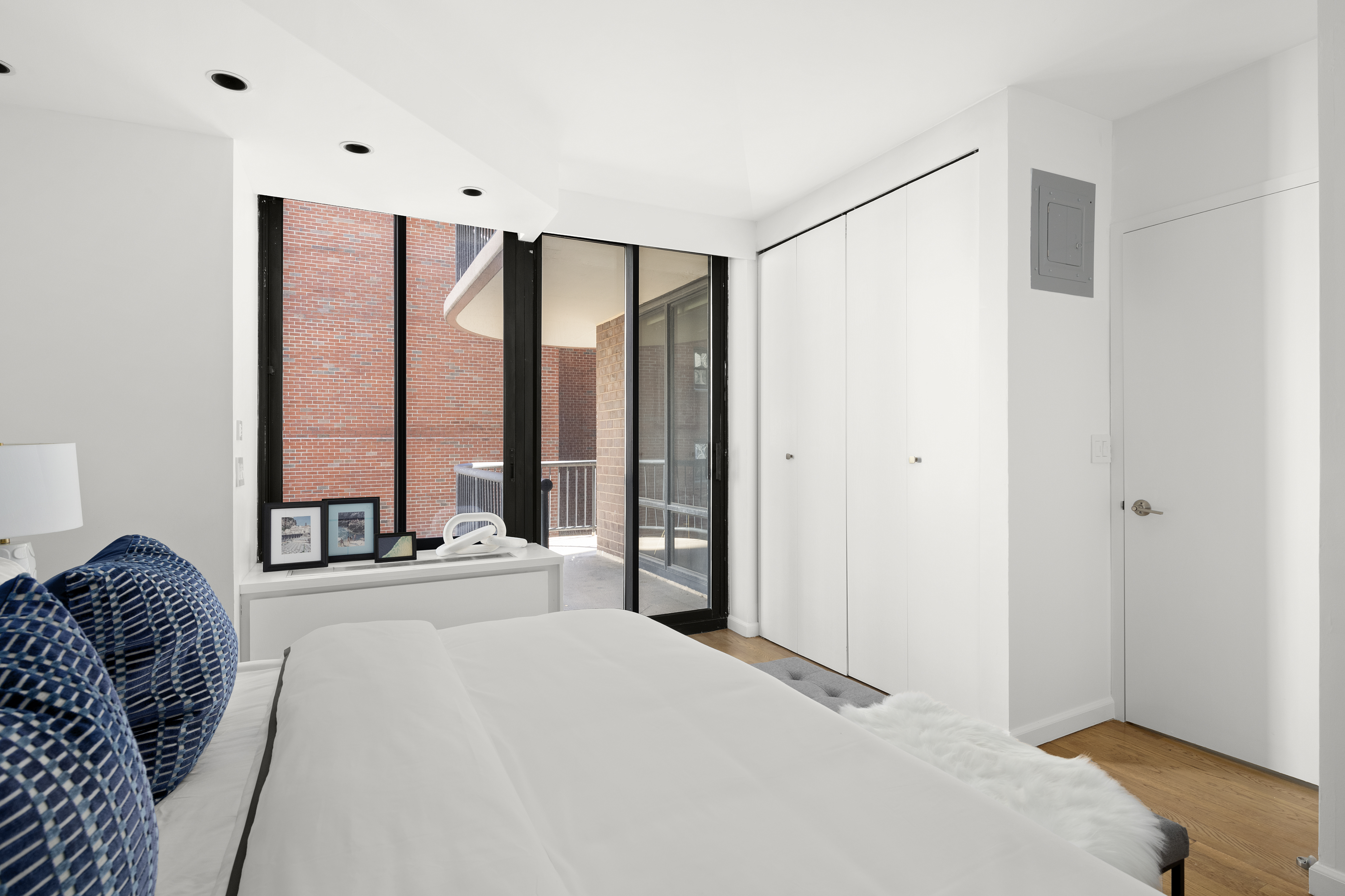 304 East 65th Street, Unit 6D Manhattan, NY 10065 - Photo 4 of 15 a spacious bedroom with a large window and a bed