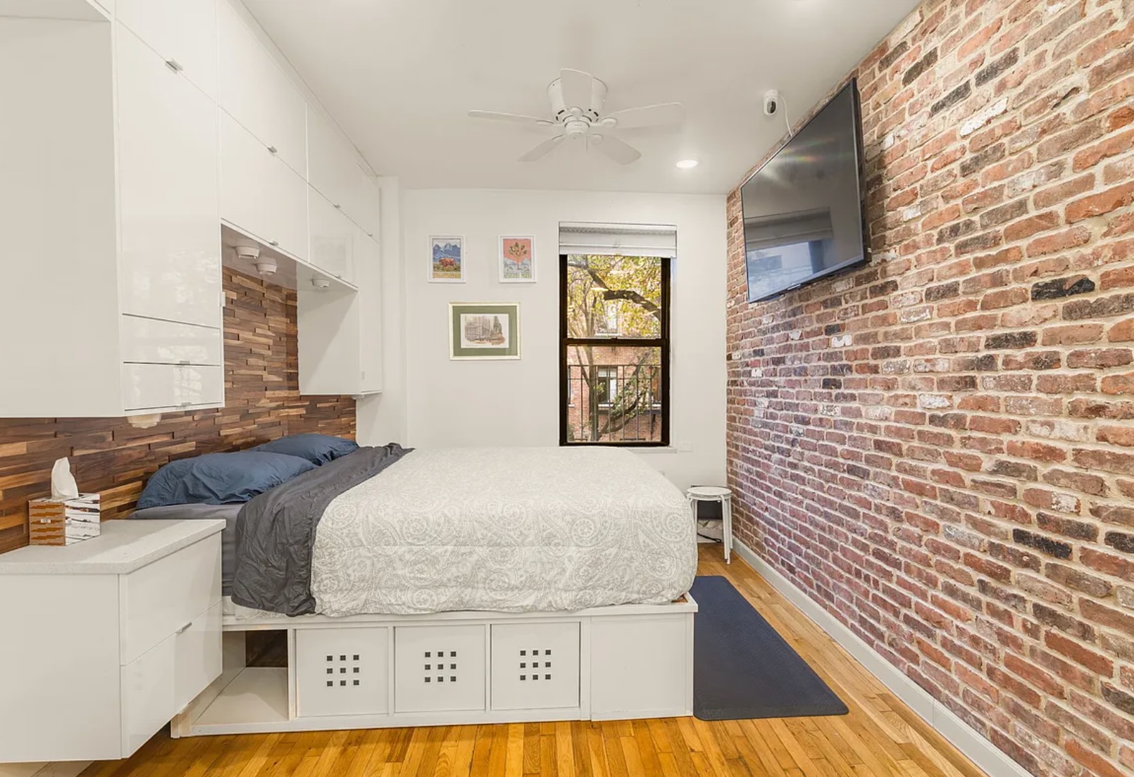 430 East 87th Street, Unit 2A Manhattan, NY 10128 - Photo 3 of 8 a bedroom with a bed and a flat screen tv