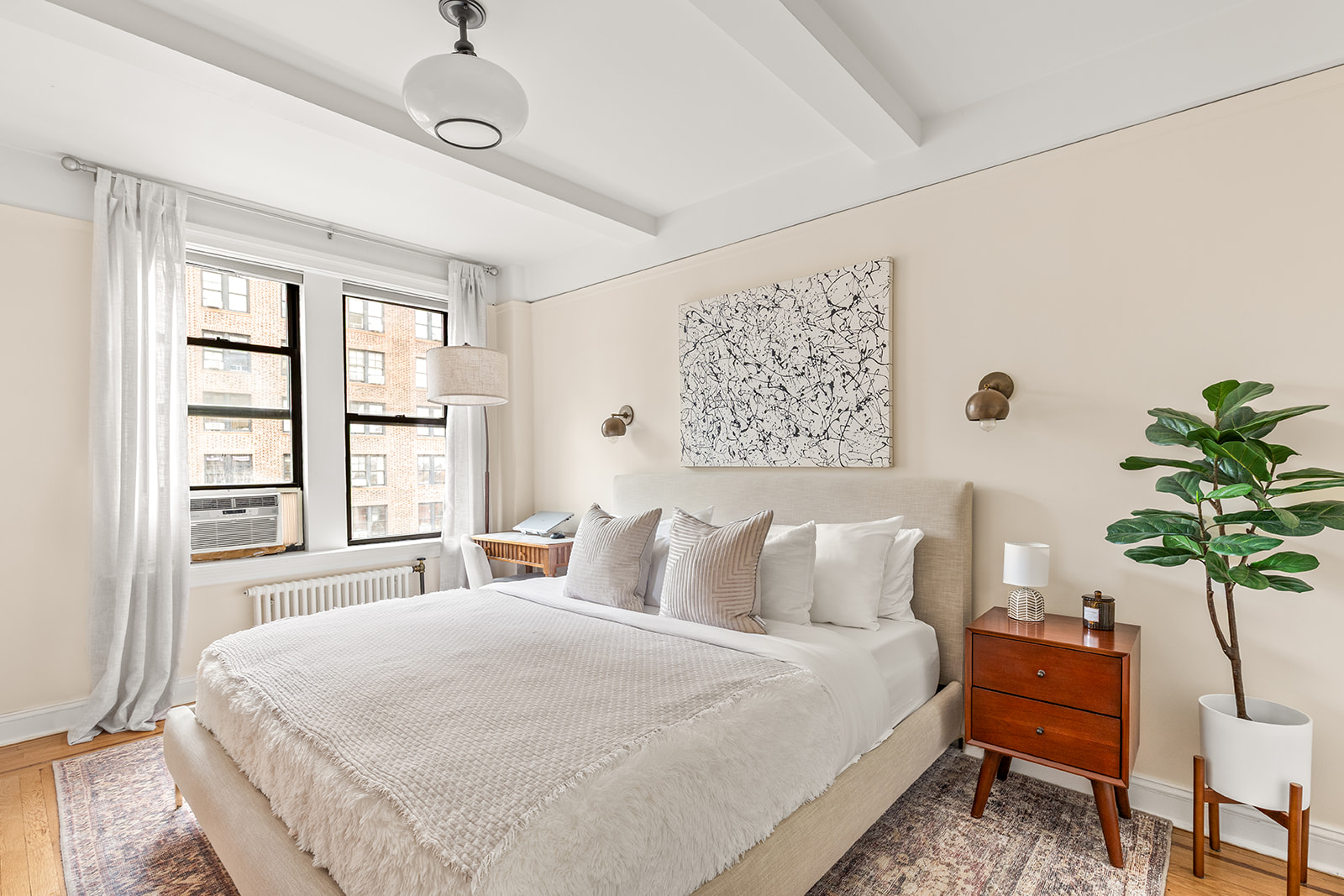 41 West 72nd Street, Unit 10B Manhattan, NY 10023 - Photo 4 of 7 a bedroom with a bed and a potted plant