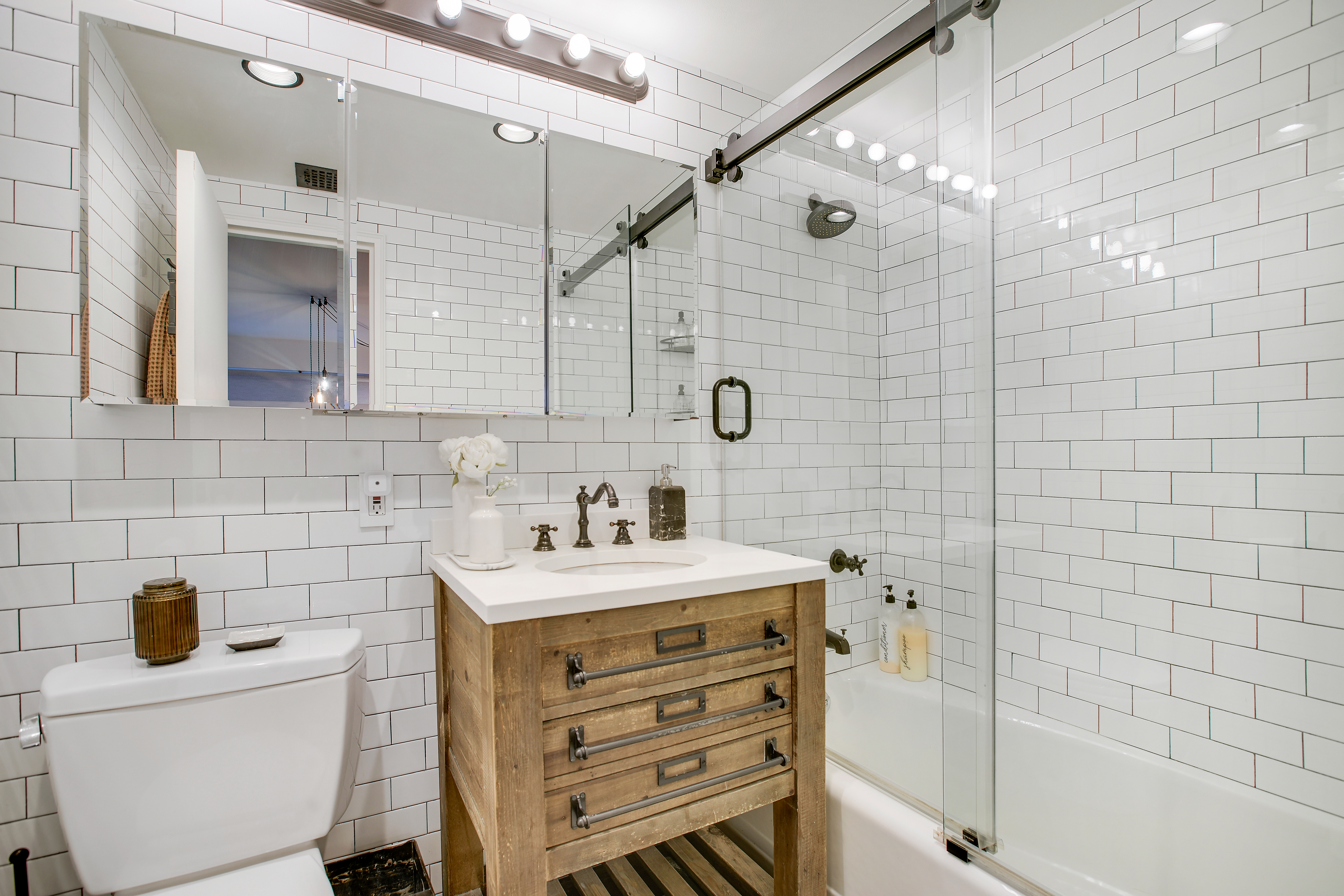 175 East 62nd Street, Unit 18B Manhattan, NY 10065 - Photo 11 of 18 a bathroom with a sink a toilet and shower