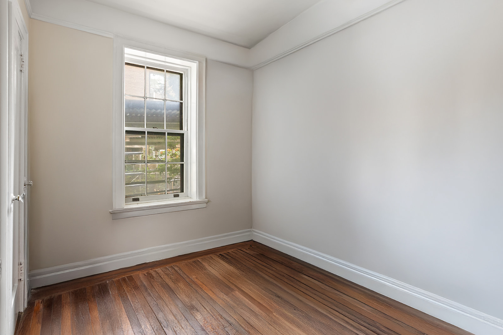 33-39 80th Street, Unit 2 Queens, NY 11372 - Photo 9 of 19 an empty room with wooden floor and windows