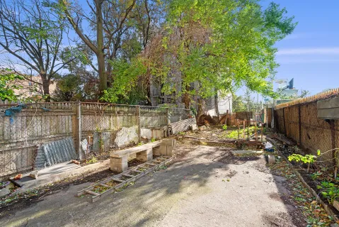 a view of a yard with wooden fence