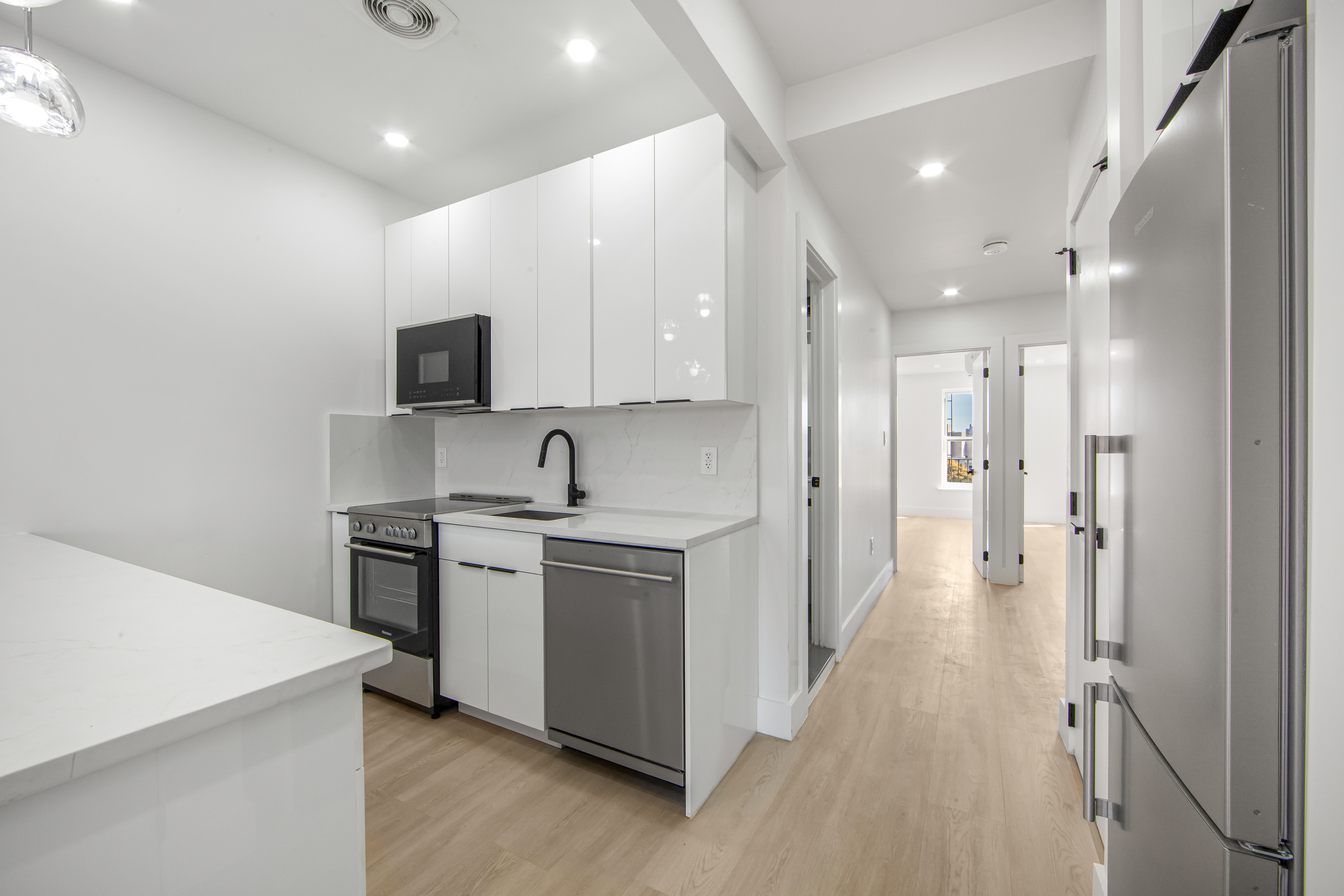 433 Court Street, Unit PH3 Brooklyn, NY 11231 - Photo 6 of 14 a kitchen with stainless steel appliances a stove a sink a refrigerator and a microwave