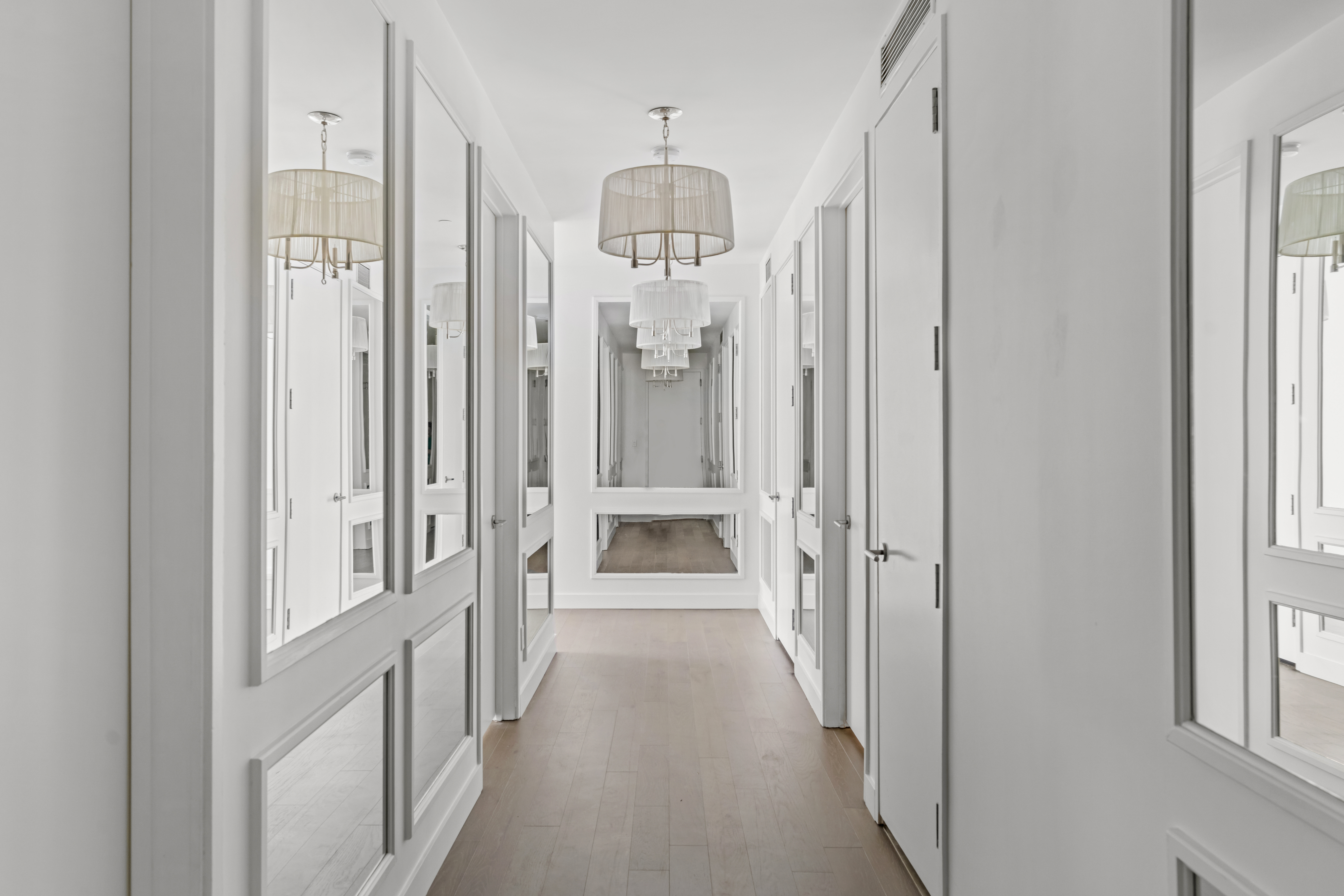 450 East 83rd Street, Unit 9E Manhattan, NY 10028 - Photo 12 of 18 a view of a hallway with a chandelier