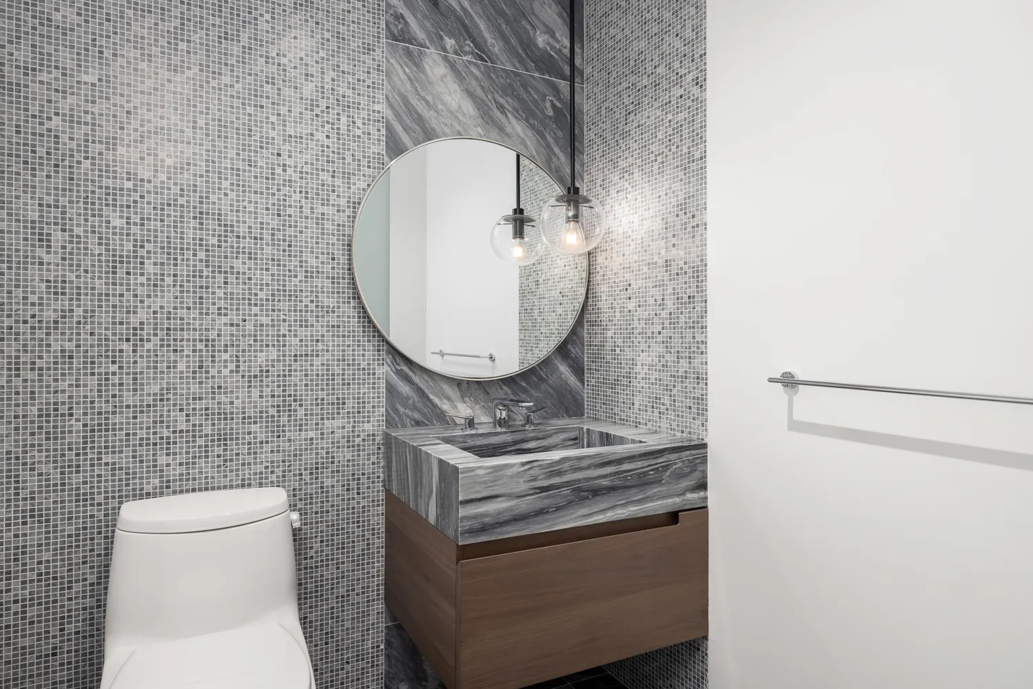 a bathroom with a toilet a sink and a mirror