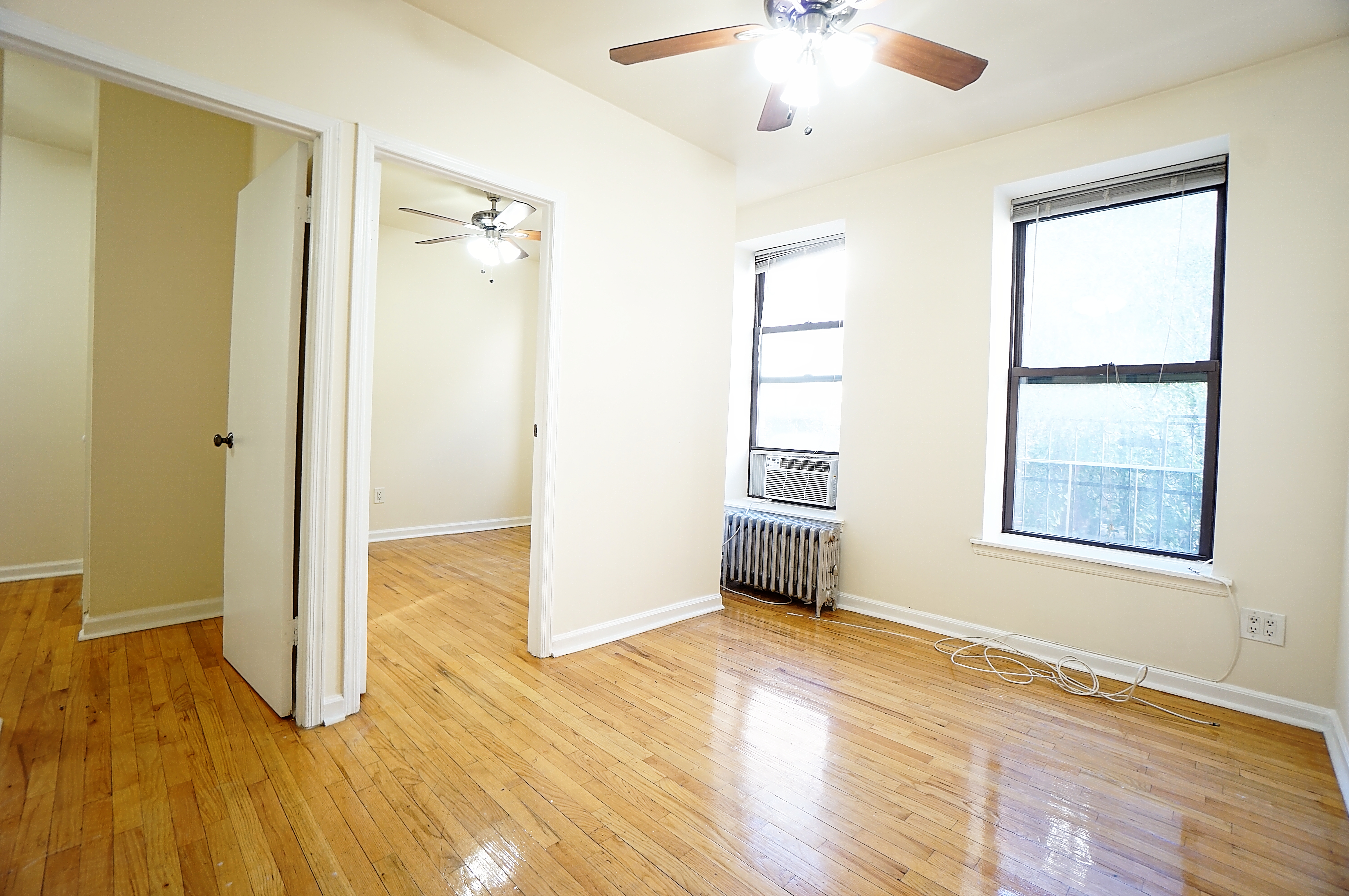 270 East 78th Street, Unit 10 Manhattan, NY 10075 - Photo 2 of 6 a view of an empty room with wooden floor and a window