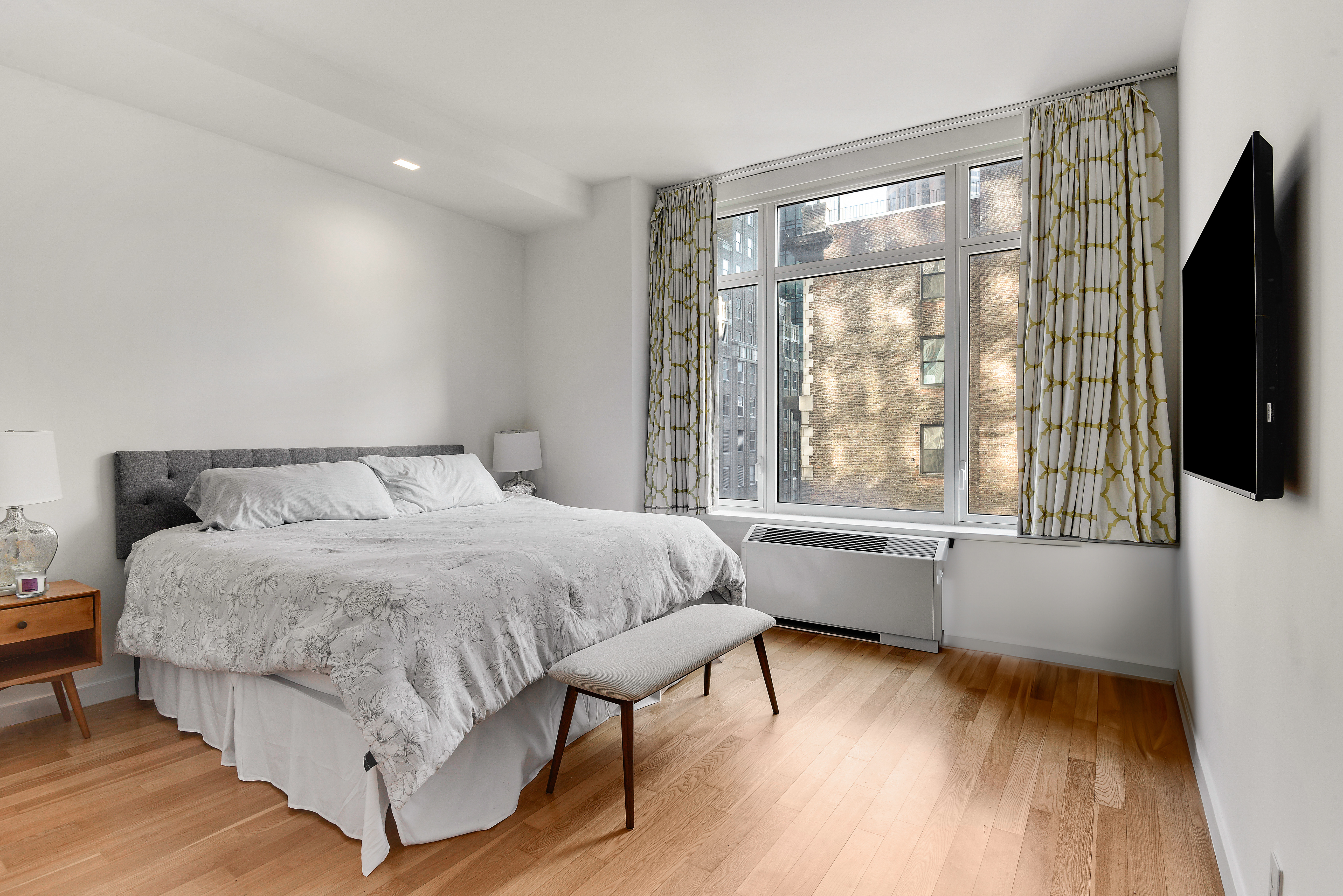 325 5th Avenue, Unit 16C Manhattan, NY 10016 - Photo 6 of 25 a bedroom with a bed and a large window