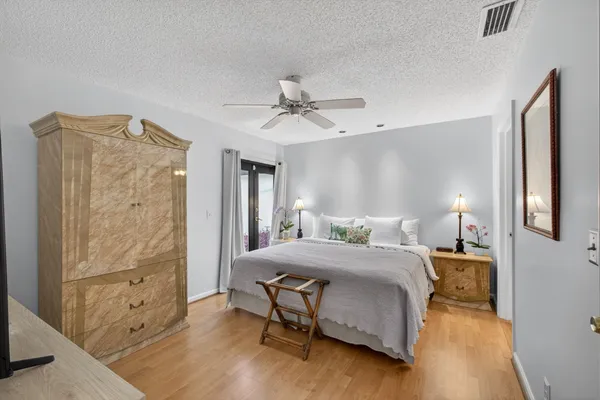 a bedroom with a bed and a table with mirror