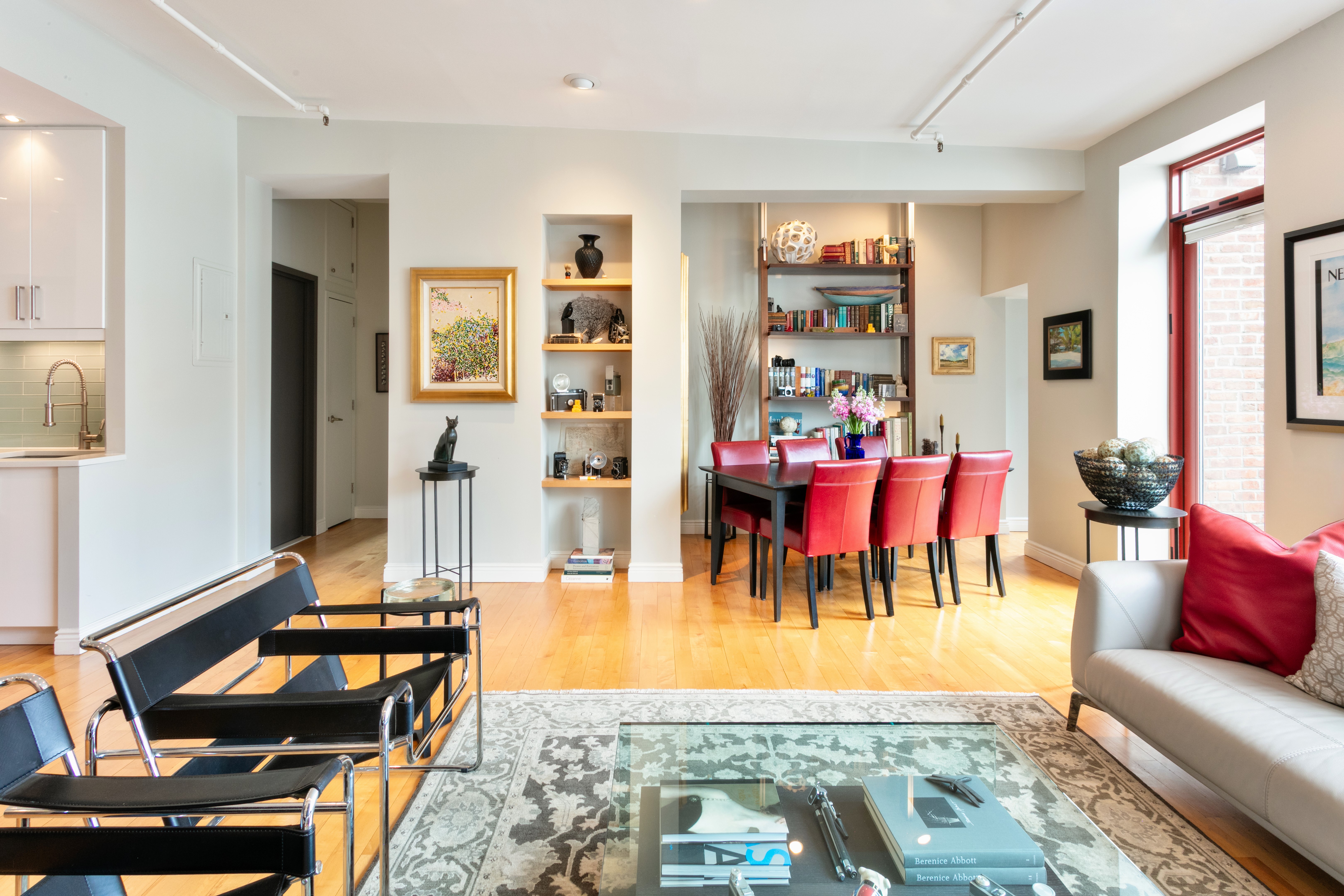 60 Tiffany Place, Unit 3C Brooklyn, NY 11231 - Photo 2 of 10 a living room with furniture and a dining table with rug