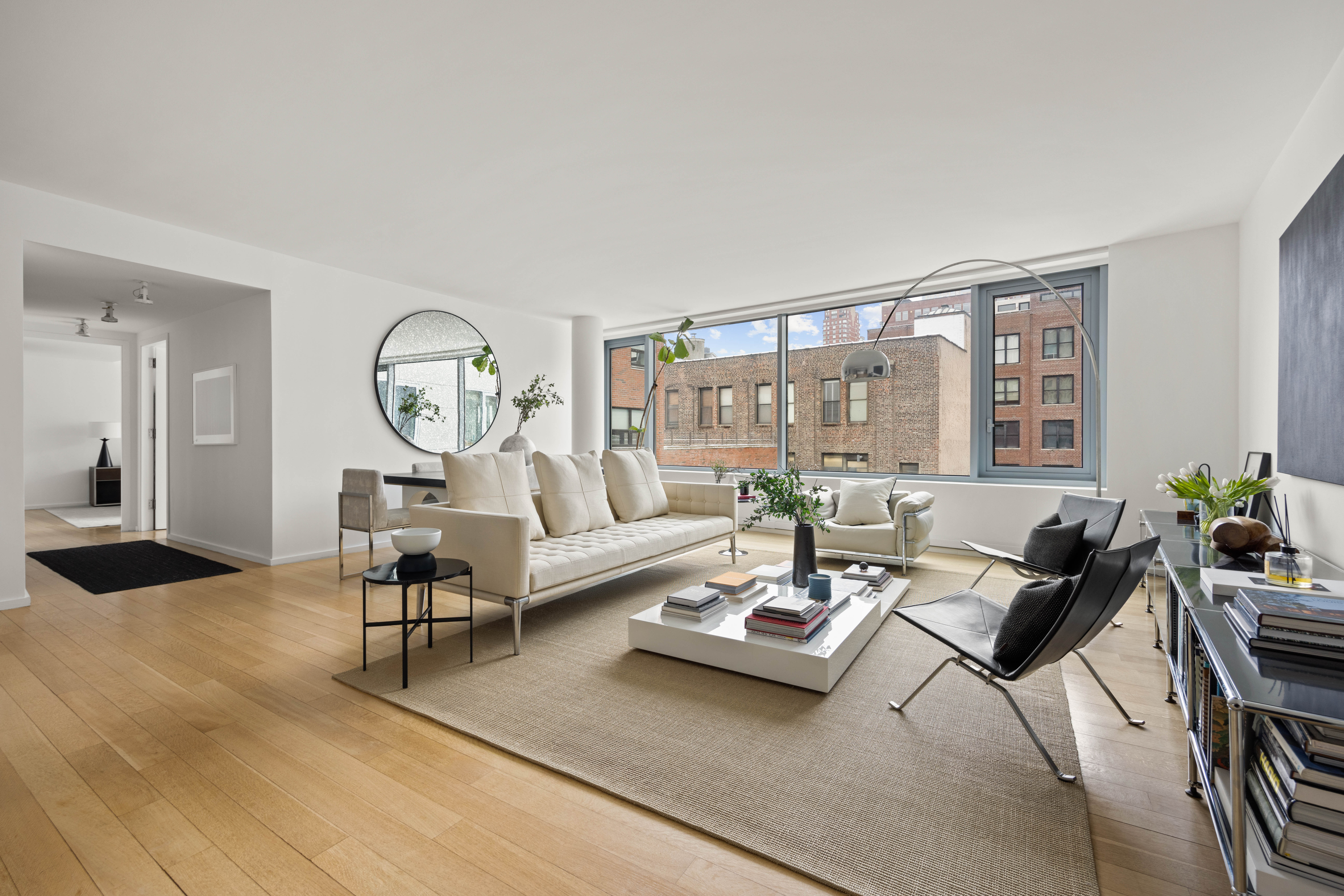 425 West 53rd Street, Unit 604 Manhattan, NY 10019 - Photo 1 of 12 a living room with furniture and wooden floor