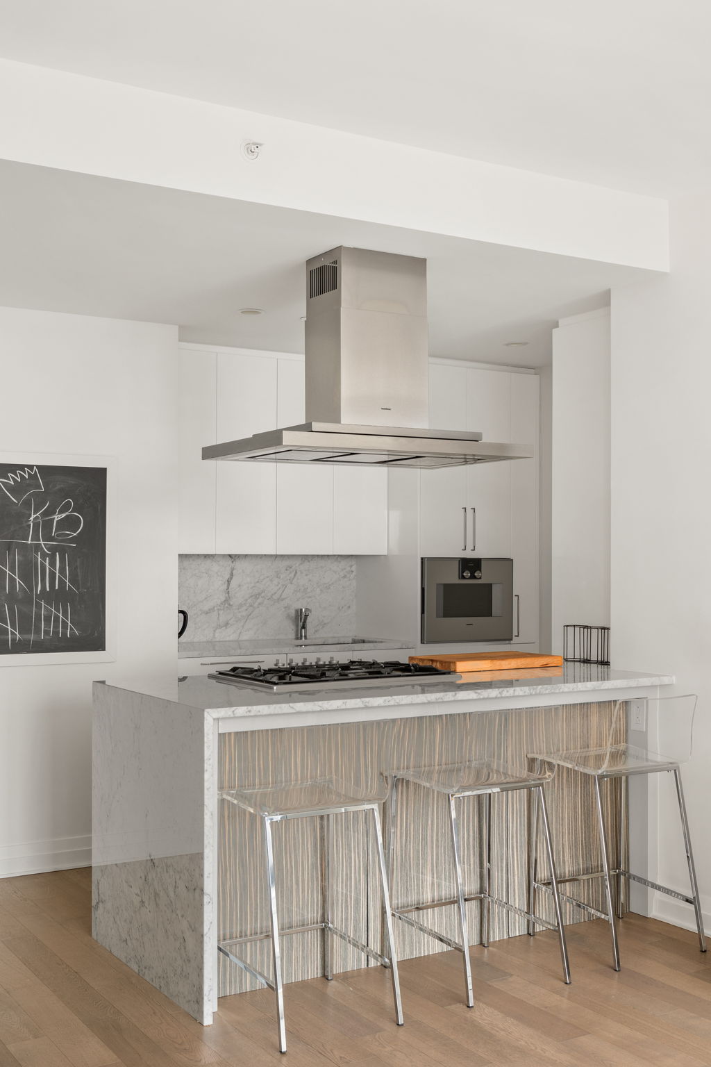 460 West 42nd Street, Unit 55F Manhattan, NY 10036 - Photo 4 of 9 a kitchen with stainless steel appliances granite countertop a sink and a stove