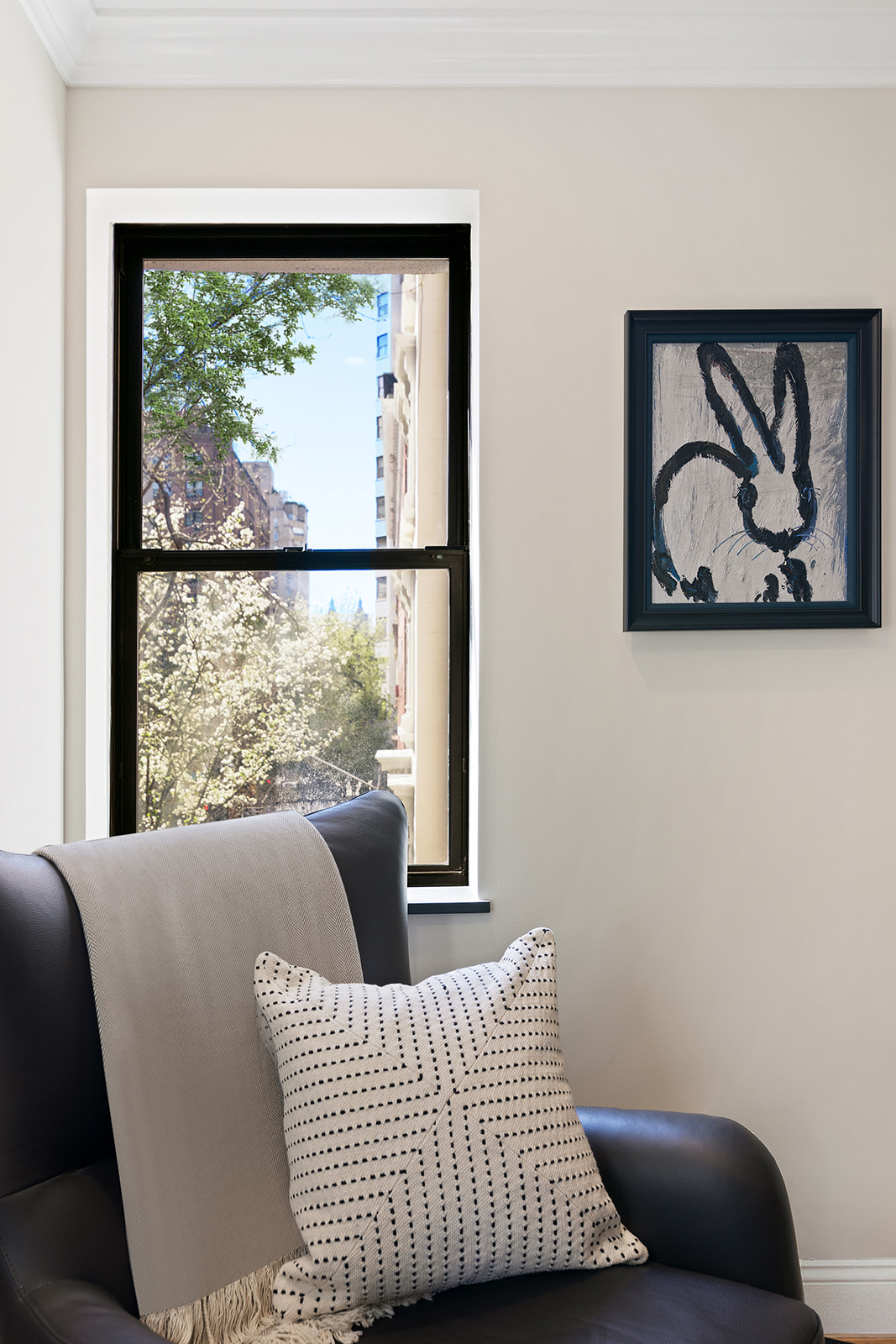 57 East 75th Street, Unit 2F Manhattan, NY 10021 - Photo 9 of 10 a living room with a couch and a window