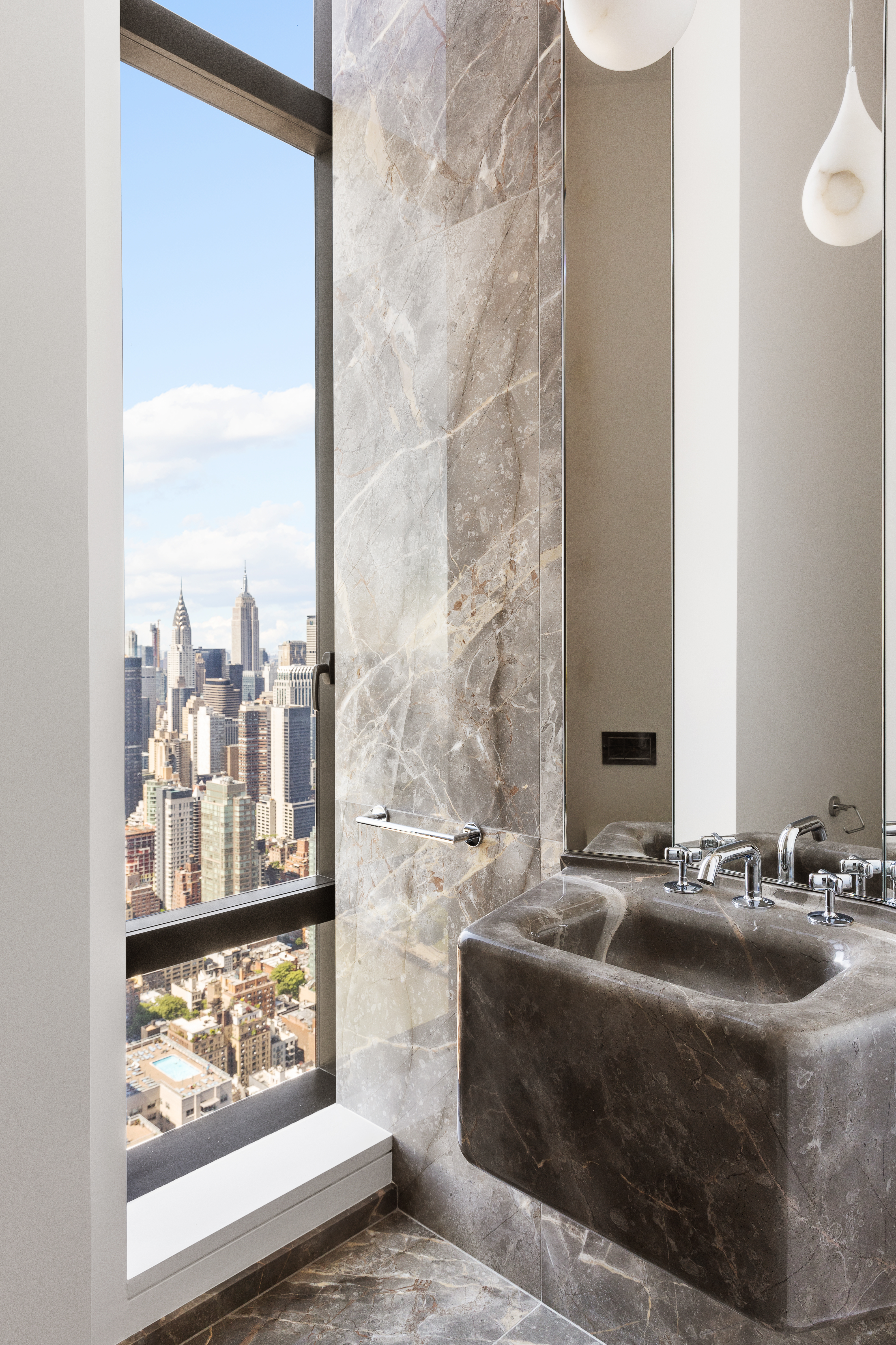 430 East 58th Street, Unit PH71 Manhattan, NY 10022 - Photo 17 of 26 a bathroom with a sink and a mirror