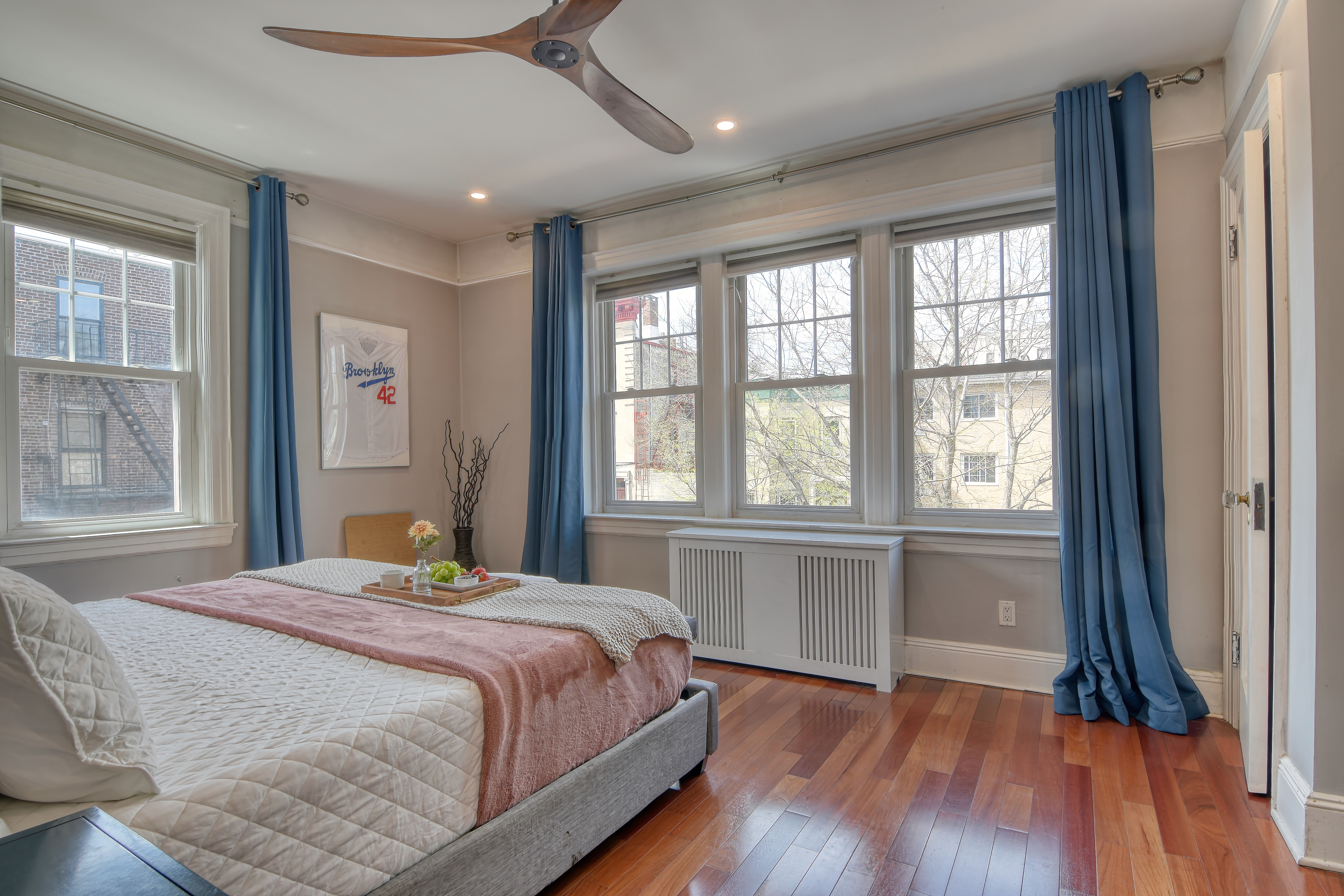 232 Maple Street Brooklyn, NY 11225 - Photo 4 of 16 a bedroom with a large bed and a large window