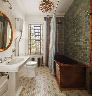 a bathroom with a sink a bathtub and a window