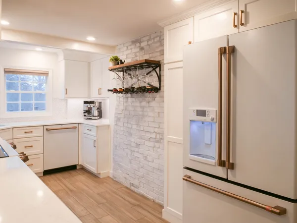 a kitchen with white cabinets and white appliances